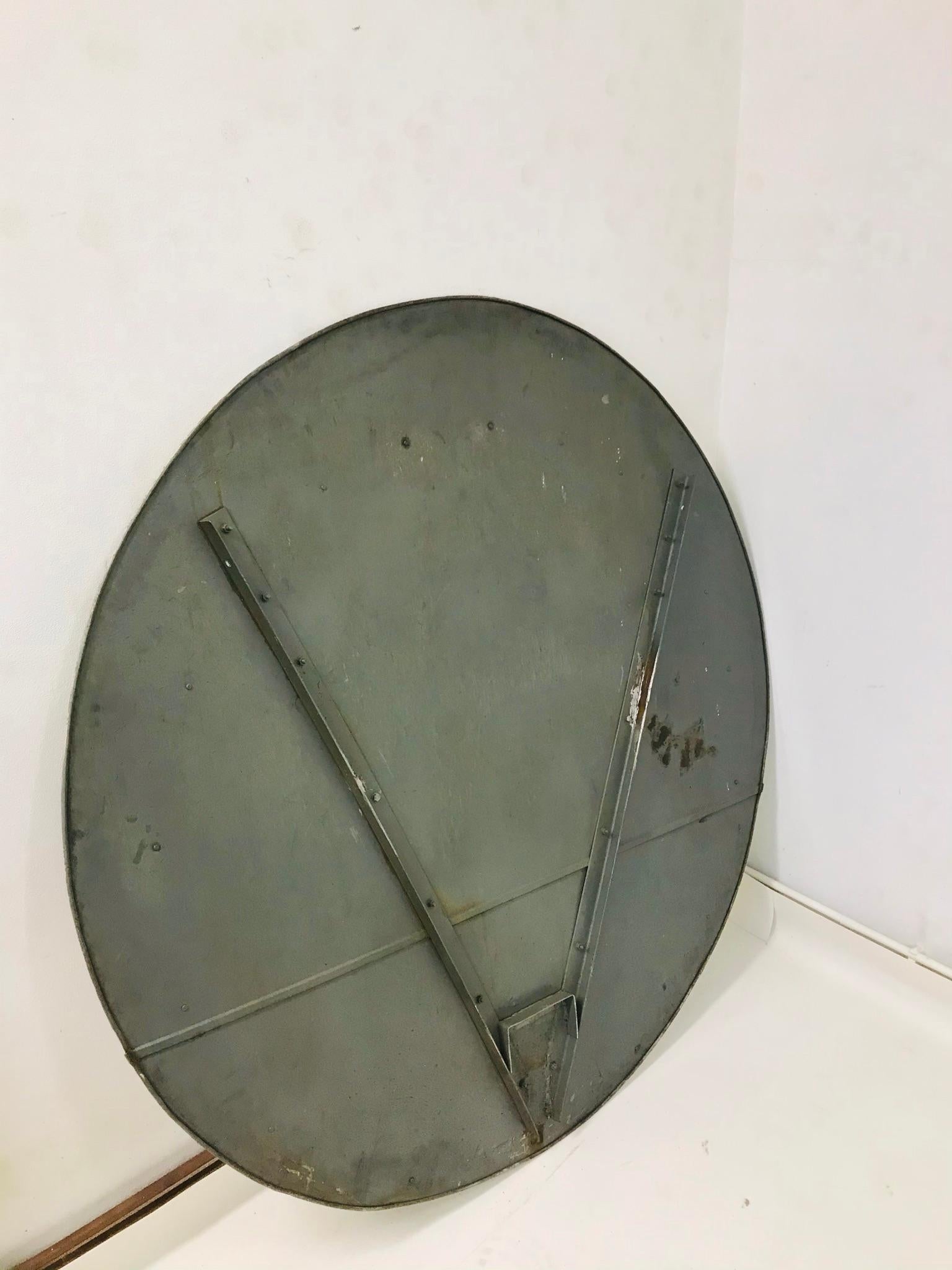 The mirror has got the metal rim with the steel construction and the convex glass. The mirror is used but it is in original with patina.