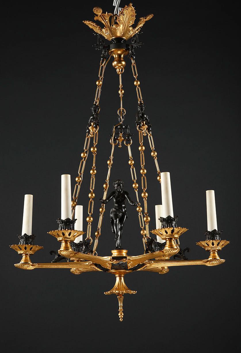 A six-light arms chandelier attributed to F. Barbedienne, made in the Greek style in patinated -and gilded bronze, presenting in the middle of which a Greek dancer, wearing a lion skin and playing the crotales, sometimes called antique