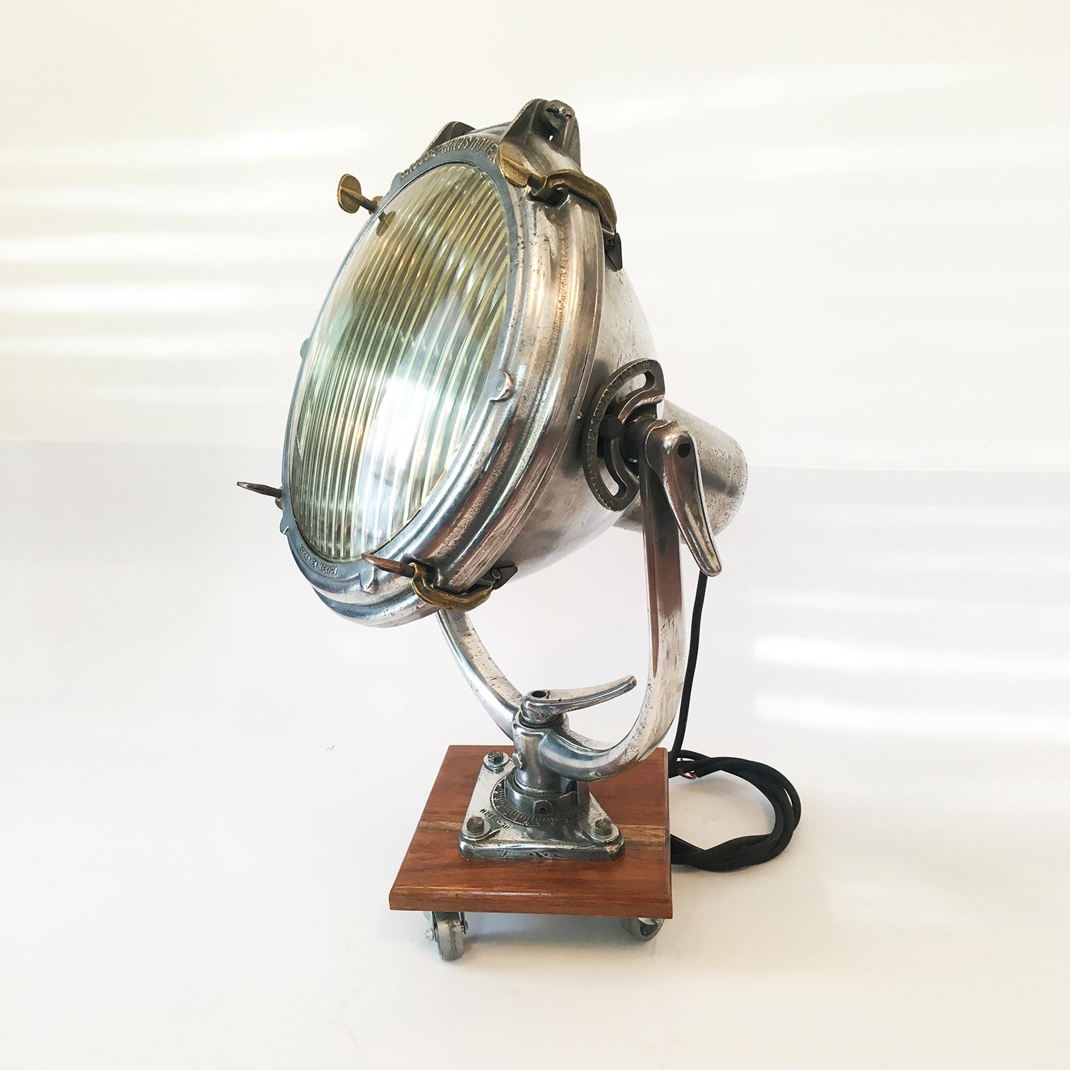 Vintage nautical or industrial ship spotlight by Crouse Hinds, mounted on wood base, circa 1930. The electrical system was changed for perfect operation.