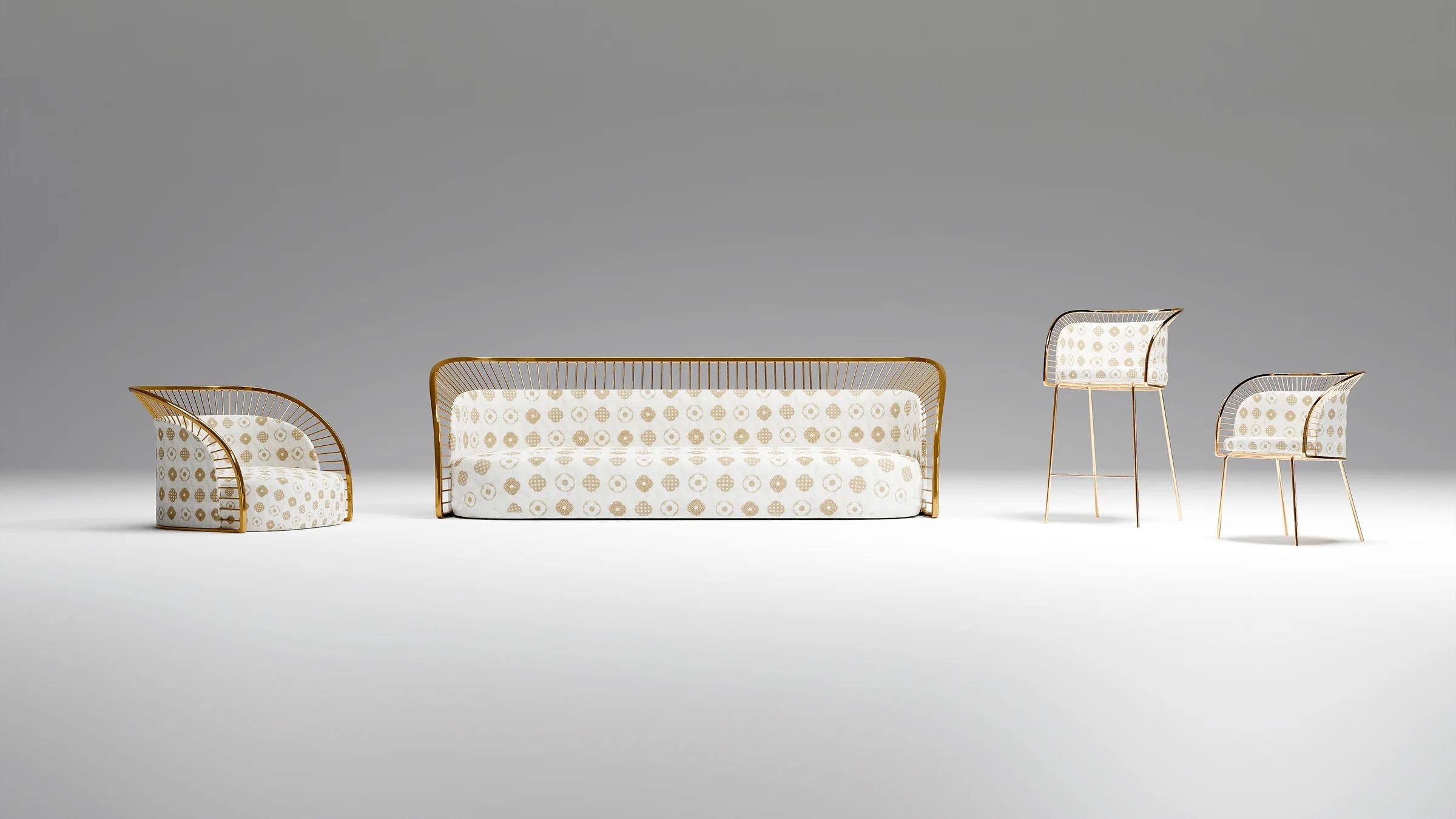 The Crown Chair is comfortable, stylish and luxurious, set in a gold halo like metal frame and embroidered fabric with the Scarlet Splendour logo. 
Inspired by the timeless symbol of the halo, the CROWN collection by Bellavista and Piccini for