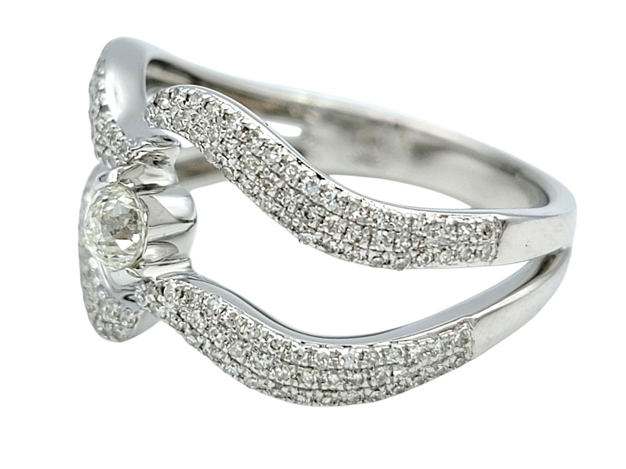 Ring Size: 7

This charming diamond ring effortlessly blends vintage elegance with modern sophistication. Crafted in 14 karat white gold, the design showcases graceful waves of pavé-set diamonds that create a sense of movement and sparkle. The