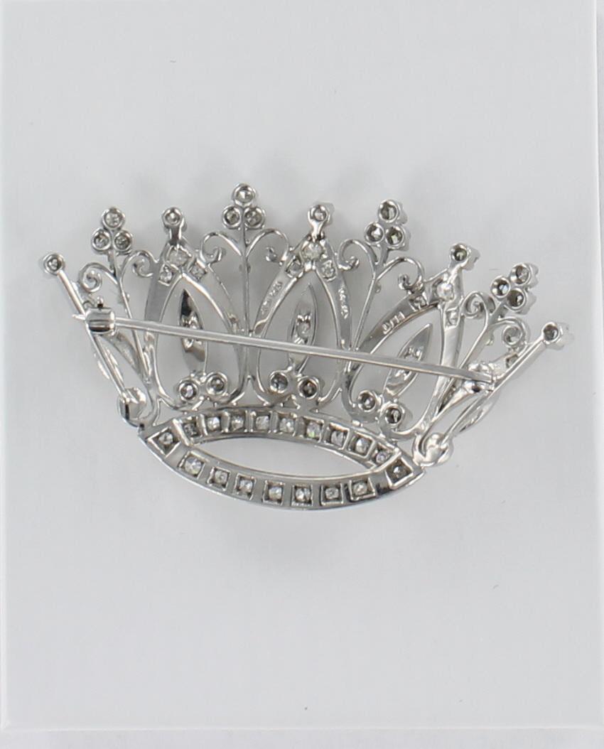 1.0 carat total weight of diamonds illuminate this fantastic platinum crown pin. The openwork pin is artfully-designed and measures 2 1/8 inch wide and 1 1/4 inch high. a fabulous wardrobe accessory.