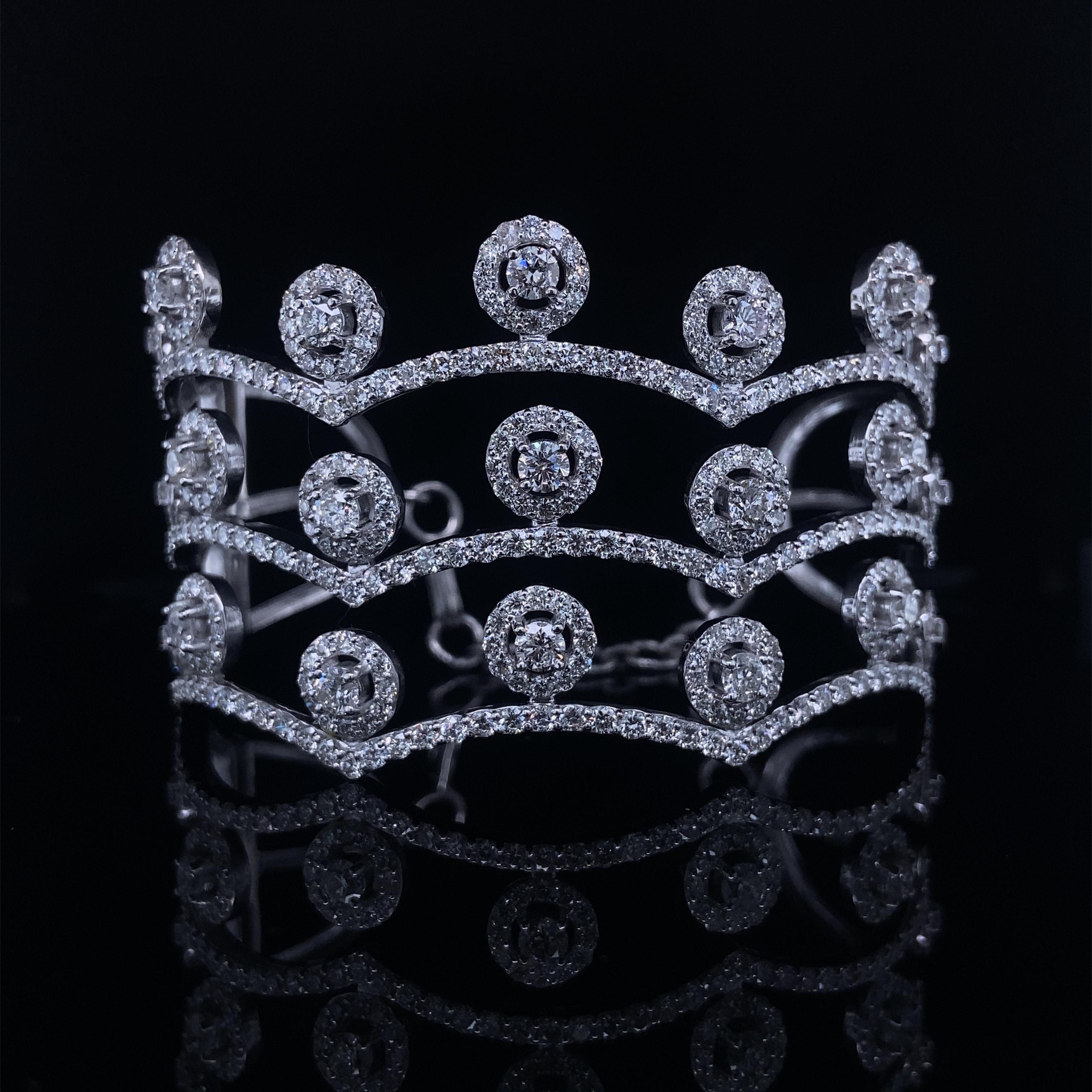 The Crown Shaped Diamond Cuff Bracelet is an exquisite piece of jewelry crafted with elegance. It features a stunning crown design meticulously set with sparkling diamonds, creating a regal and luxurious appearance. The bracelet is expertly crafted