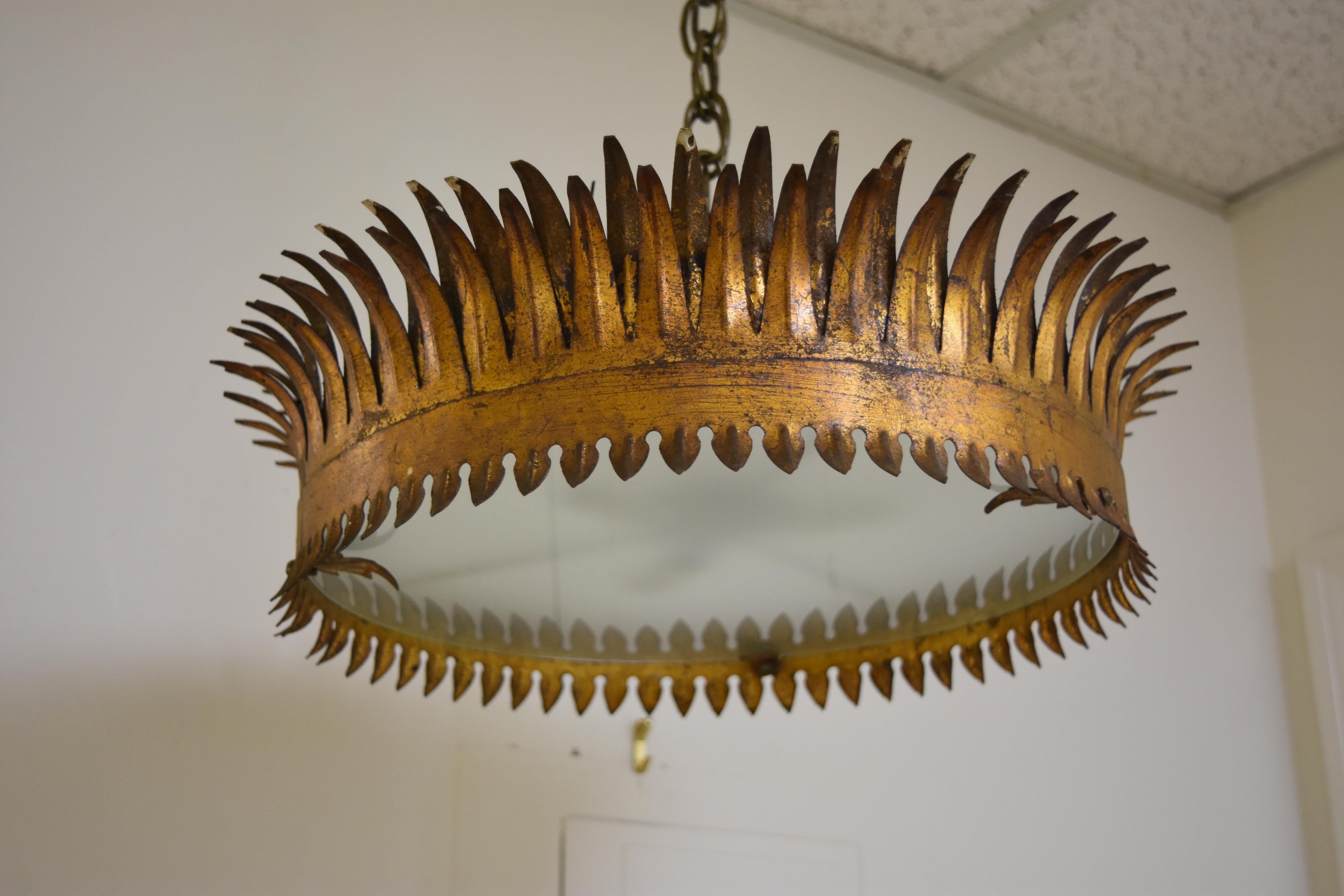 This early 20th century light fixture is a crown shape with three lights. It has been newly rewired for American use. The light is diffused shining through a piece of frosted glass held in place by three small gold metal leaves. Two of the leaves