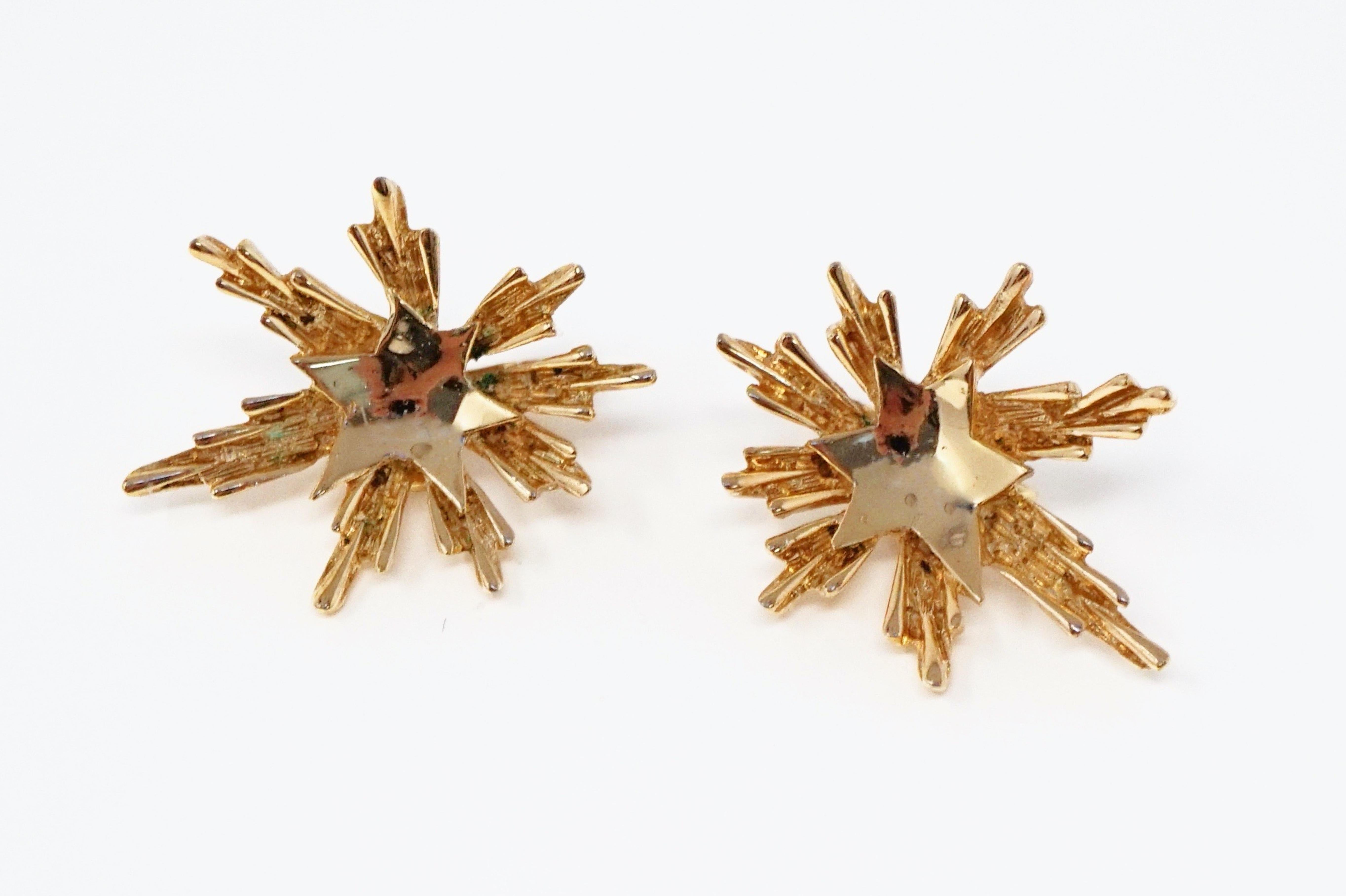 Gorgeous gold-plated clip-on earrings by Trifari, circa 1950s. Trifari is a highly collected costume jewelry brand, noted for its quality and intricate details. These mid-century modern examples were produced during the Crown Trifari period of 1955