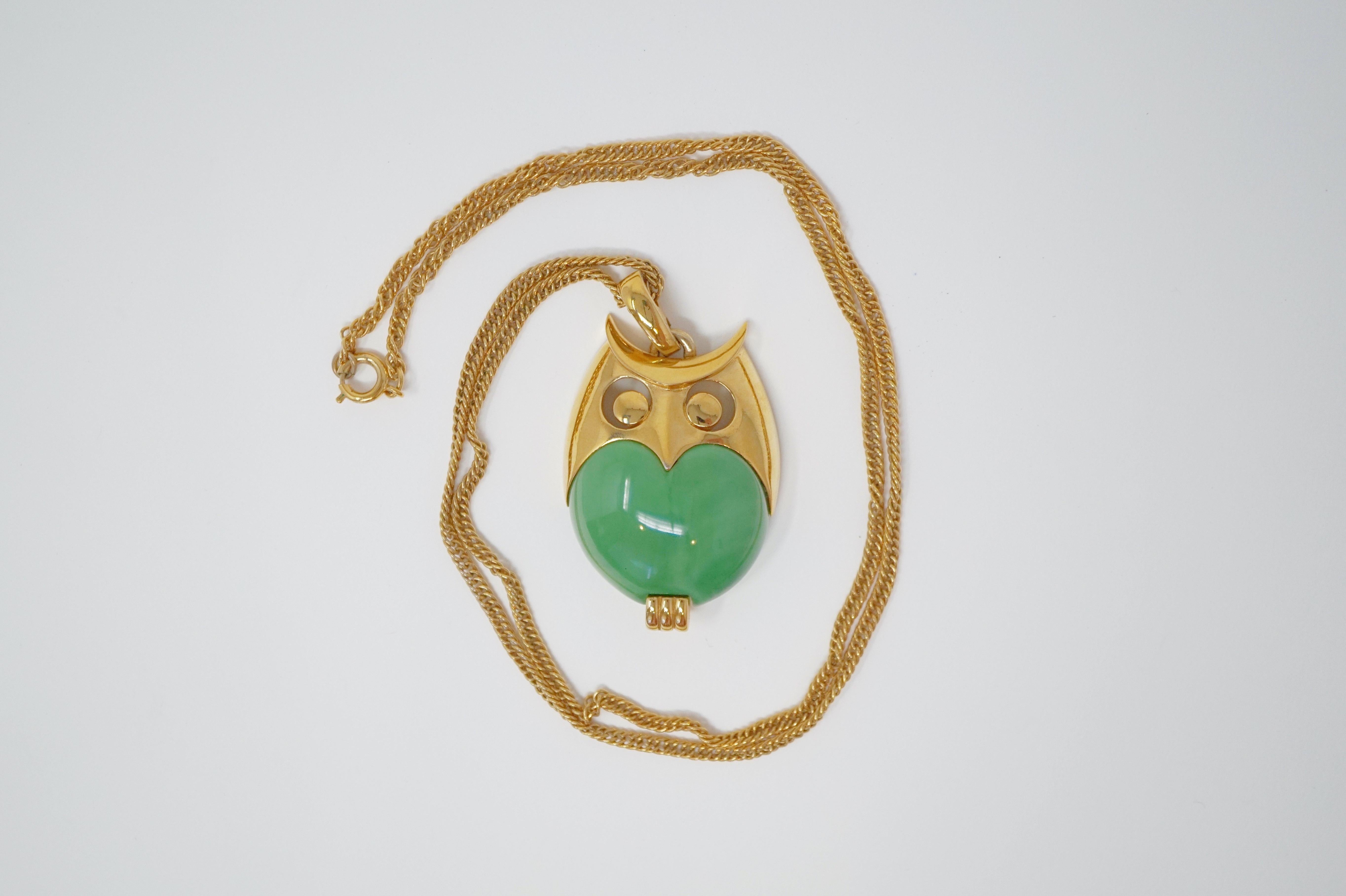 This adorable Mod-style green lucite owl pendant necklace with gold tone hardware is by Trifari, circa 1960.  Trifari is a highly collected costume jewelry brand, noted for high quality of construction and intricate details.  This piece is signed