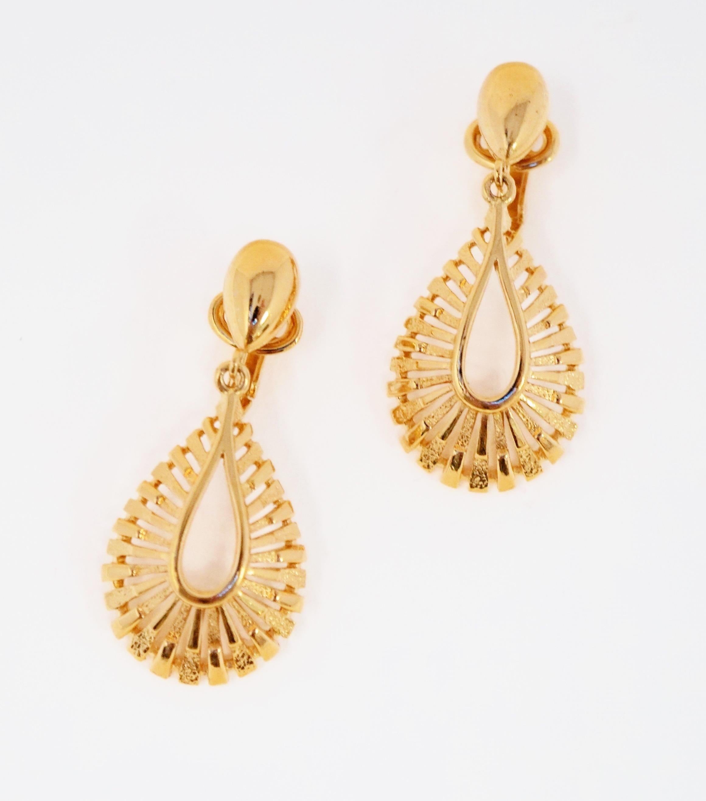 Stunningly beautiful Modernist gold-tone sunburst style clip-on dangle earrings by Trifari, circa 1955. Trifari is a highly collected costume jewelry brand, noted for it's high quality of construction and intricate details. This piece is signed on