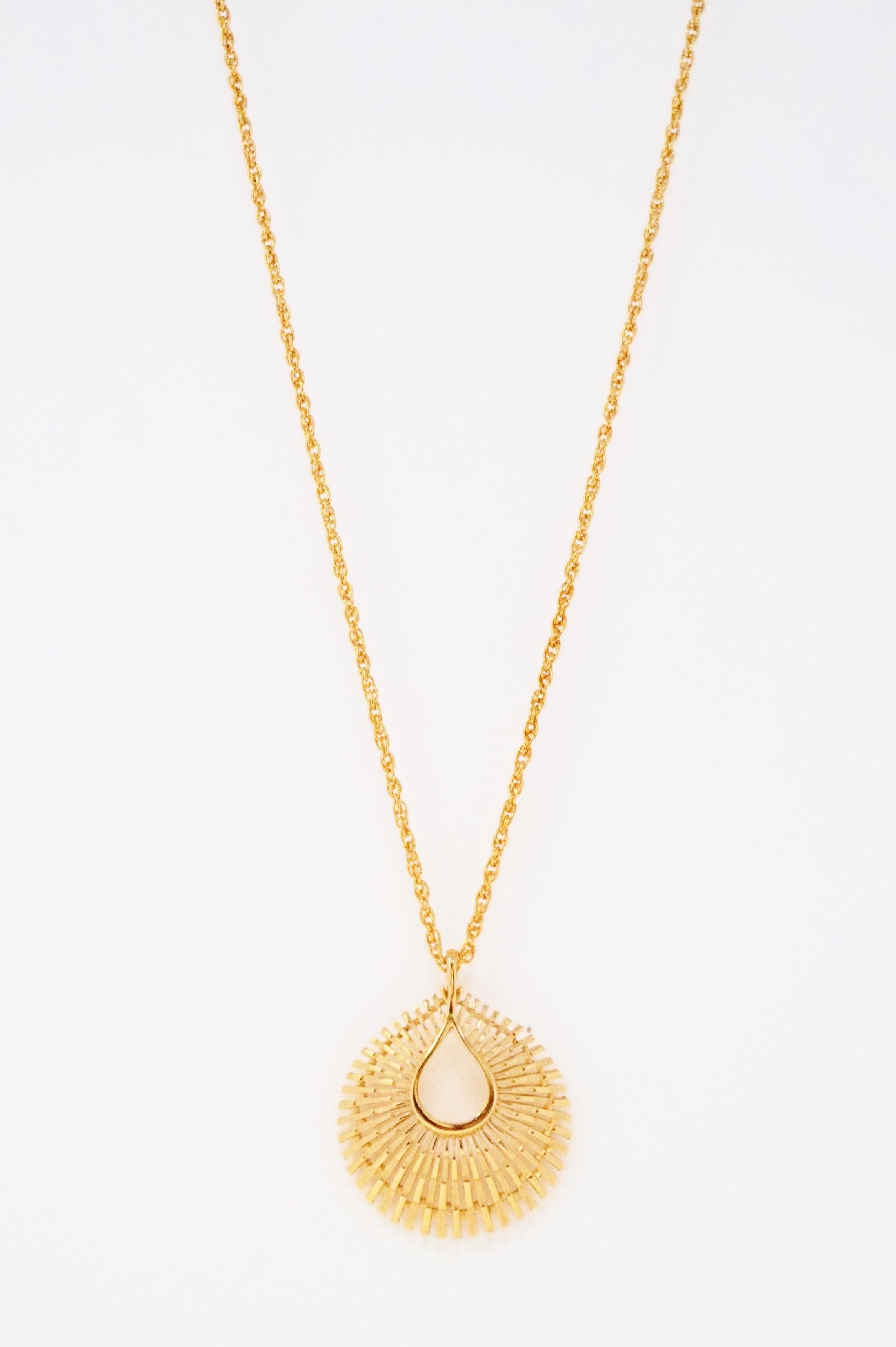 Stunningly beautiful Modernist gold-tone sunburst medallion pendant necklace by Trifari, circa 1955. Trifari is a highly collected costume jewelry brand, noted for it's high quality of construction and intricate details. This piece is signed on