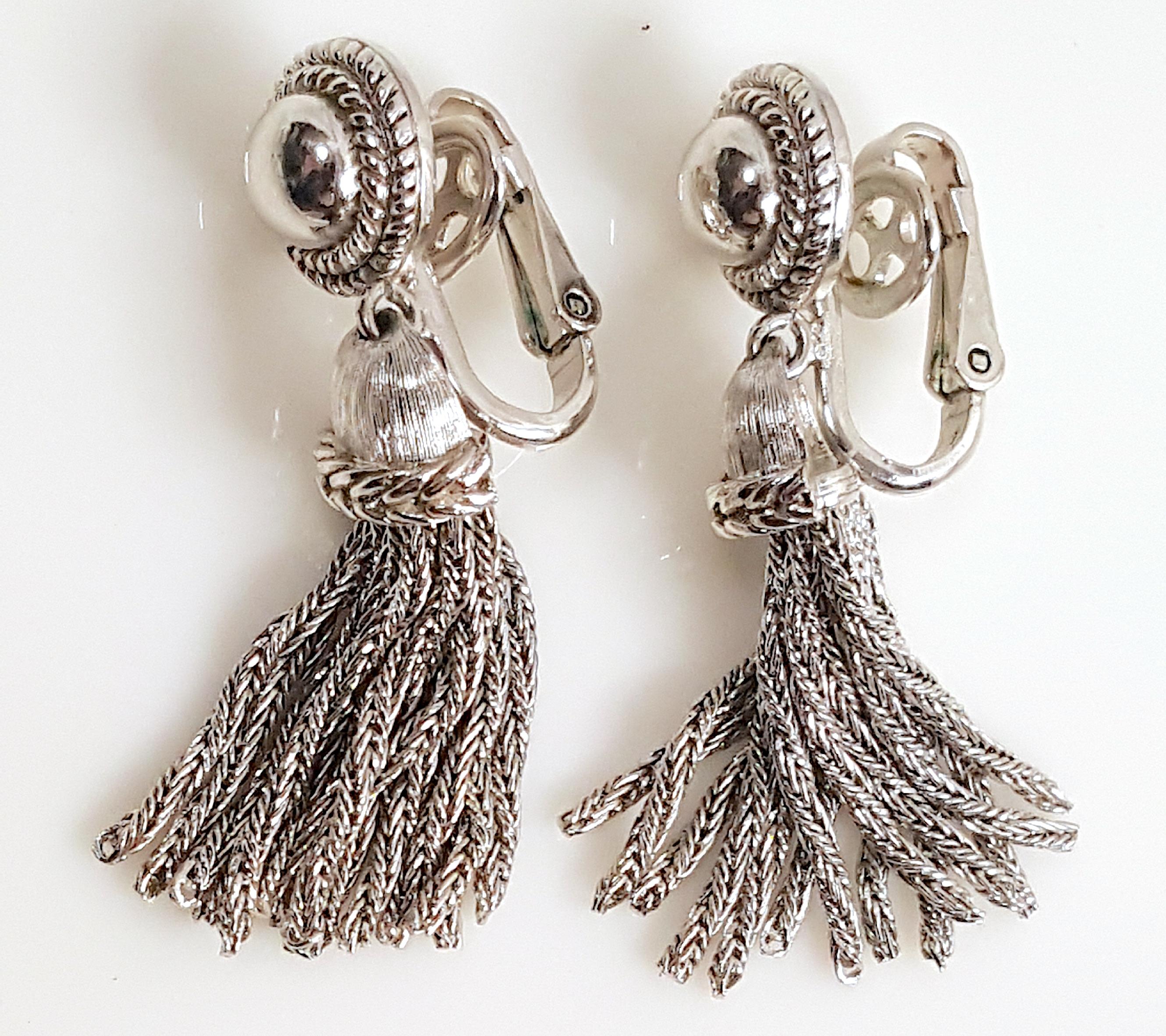 These mid-century platinum-like silver tassel chain drop earrings were designed by Trifari artistic director Alfred Philippe in an Art Deco style that recalls his earlier work for Cartier and Van Cleef & Arpels. The earrings are signed on the back