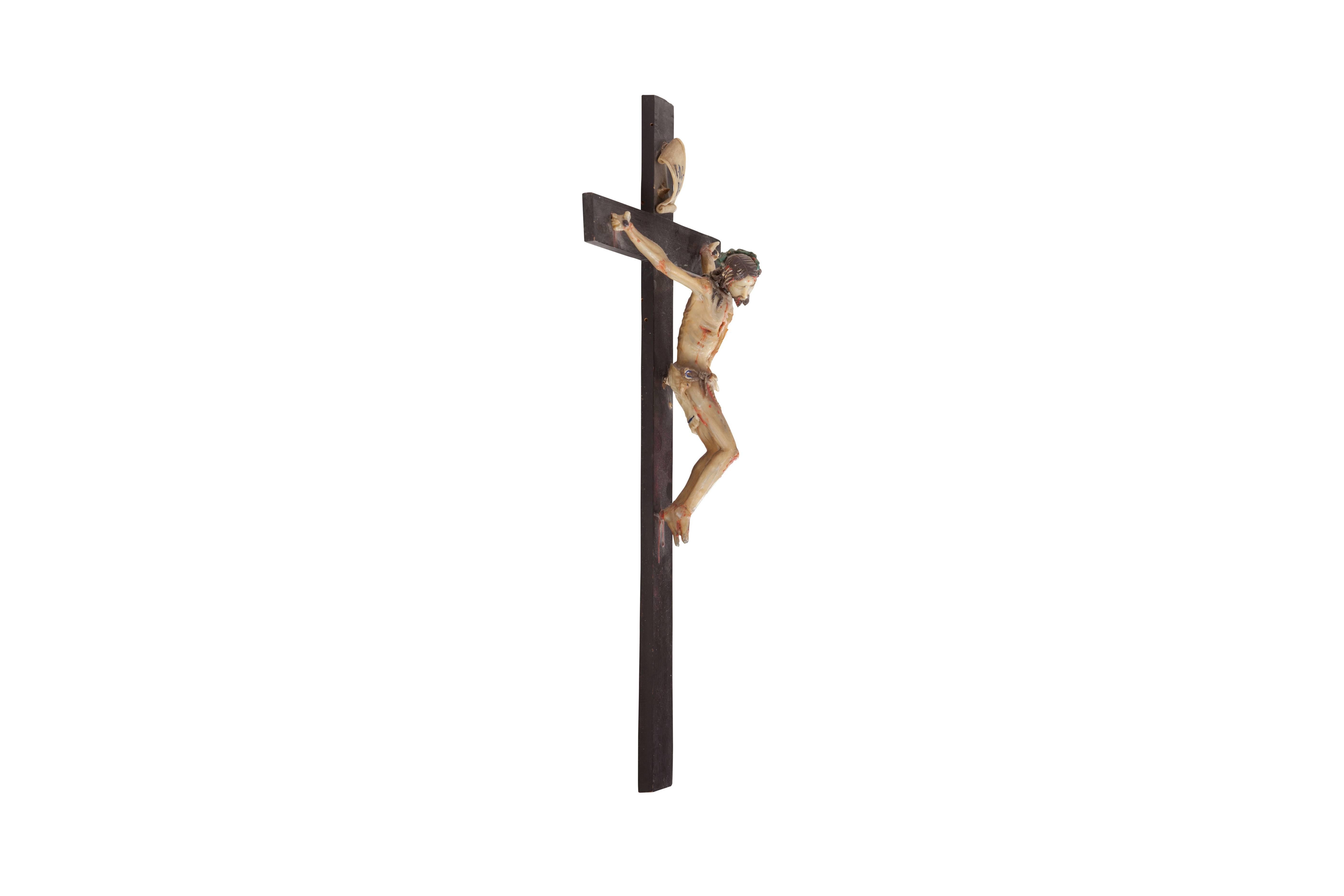 Modern translation of crucified and tortured Christ sculpture, Italy, 1960s

Above his head, there is a piece of parchment with I.N.R.I written on it, which in Latin means: Iesus Nazarenus, Rex Iudaeorum (Jesus of Nazareth, king of the