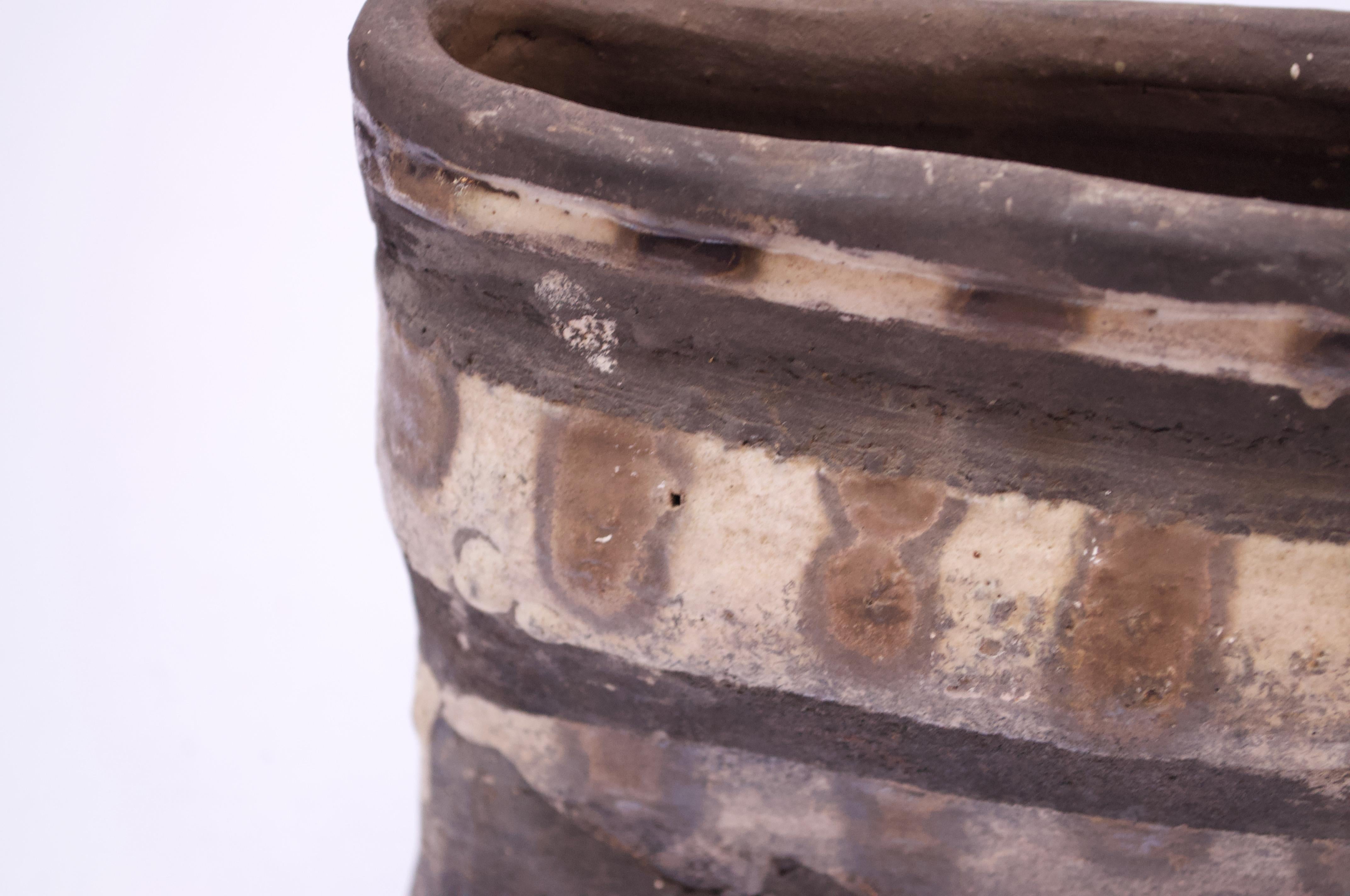 1971 Pollack handled-vase featuring a slate surface with swaths of beige and brown and blue decoration. Crude by design enhanced by the unglazed finish. Incised, partial signature present to the underside, but appears to read, 