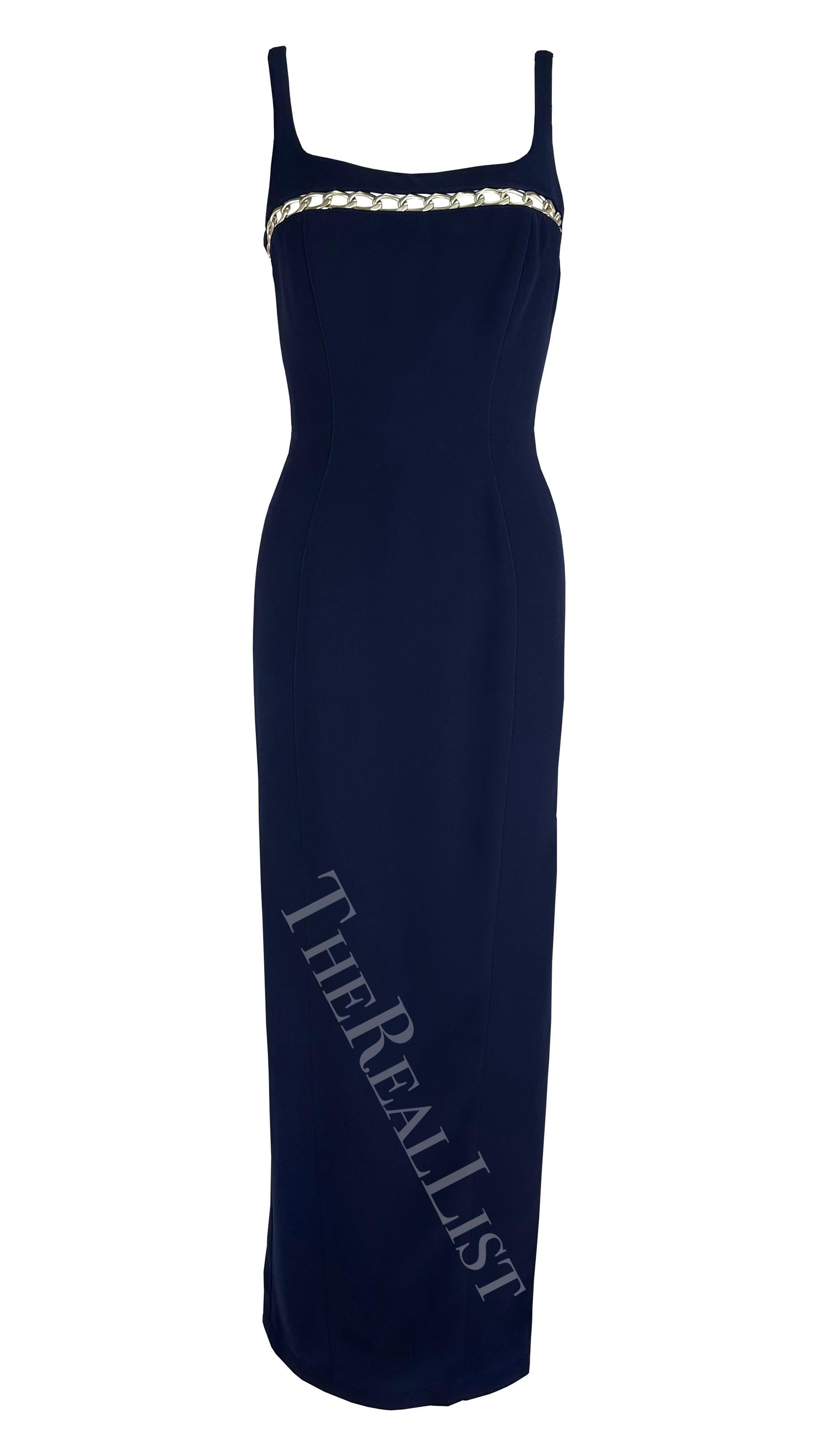 Presenting a fabulous navy blue Thierry Mugler gown, designed by Manfred Mugler. From the 1999 Cruise collection, this full-length gown features a fitted column silhouette, thin straps, and an angular neckline. The dress is made complete with a