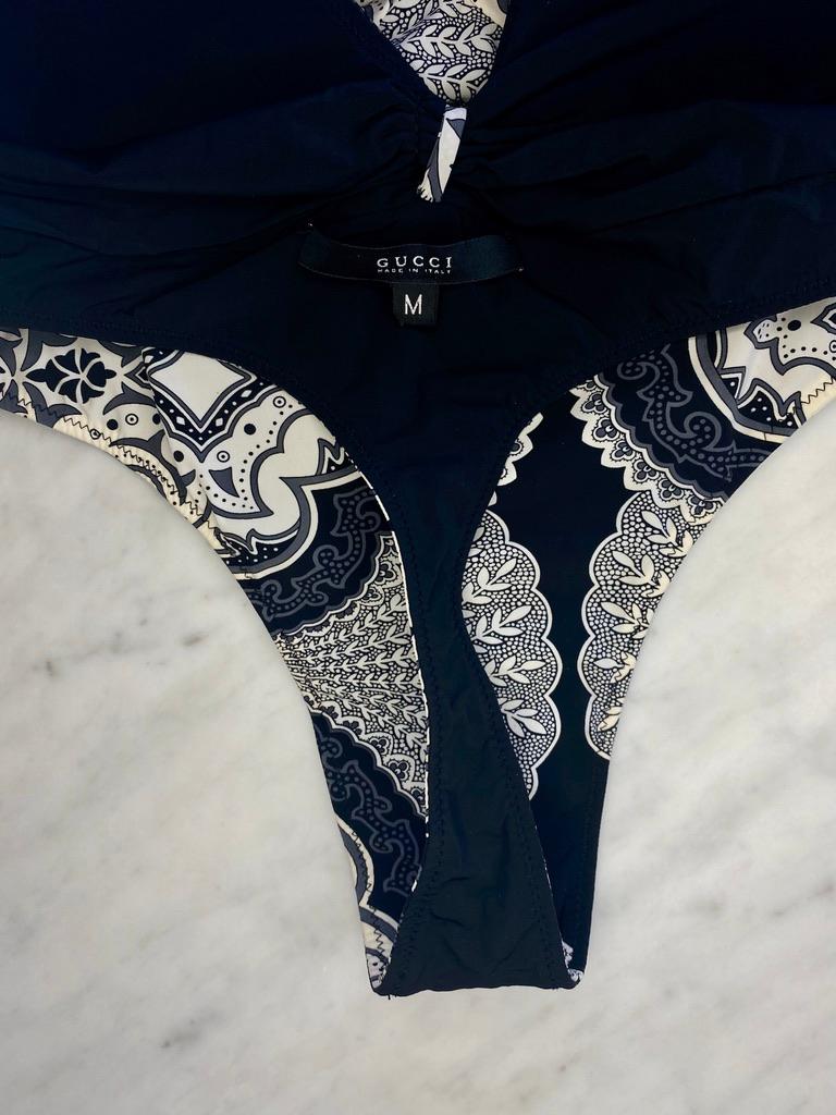 A luxury bandana print one piece swimsuit with a black and white design