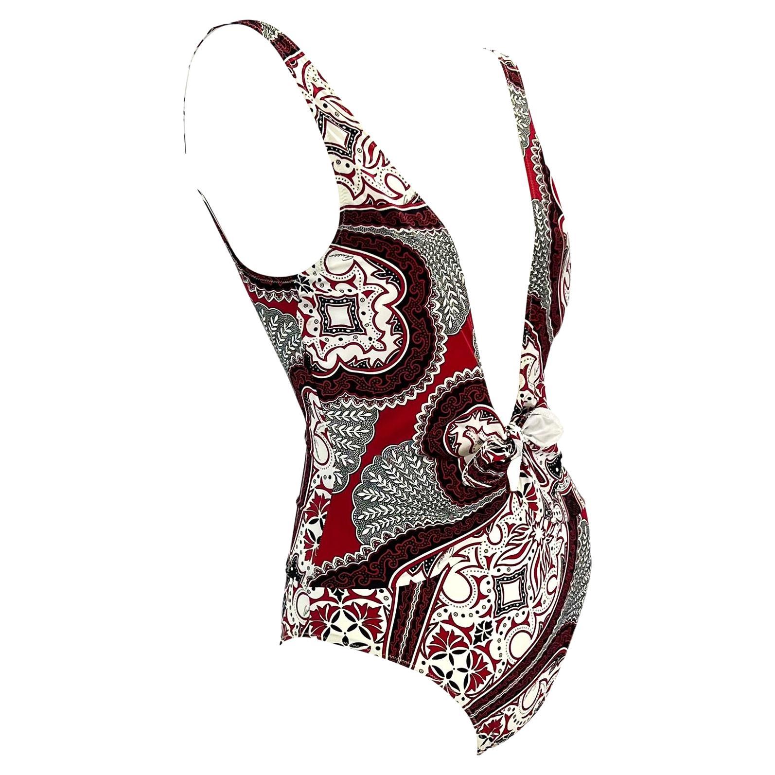 Presenting a red bandana print one piece Gucci swimsuit, designed by Tom Ford. From the 2004 cruise collection, this ultra sexy one piece features a plunging neckline with a small bow as well as a low exposed back. Nearly 20 years old and unused,