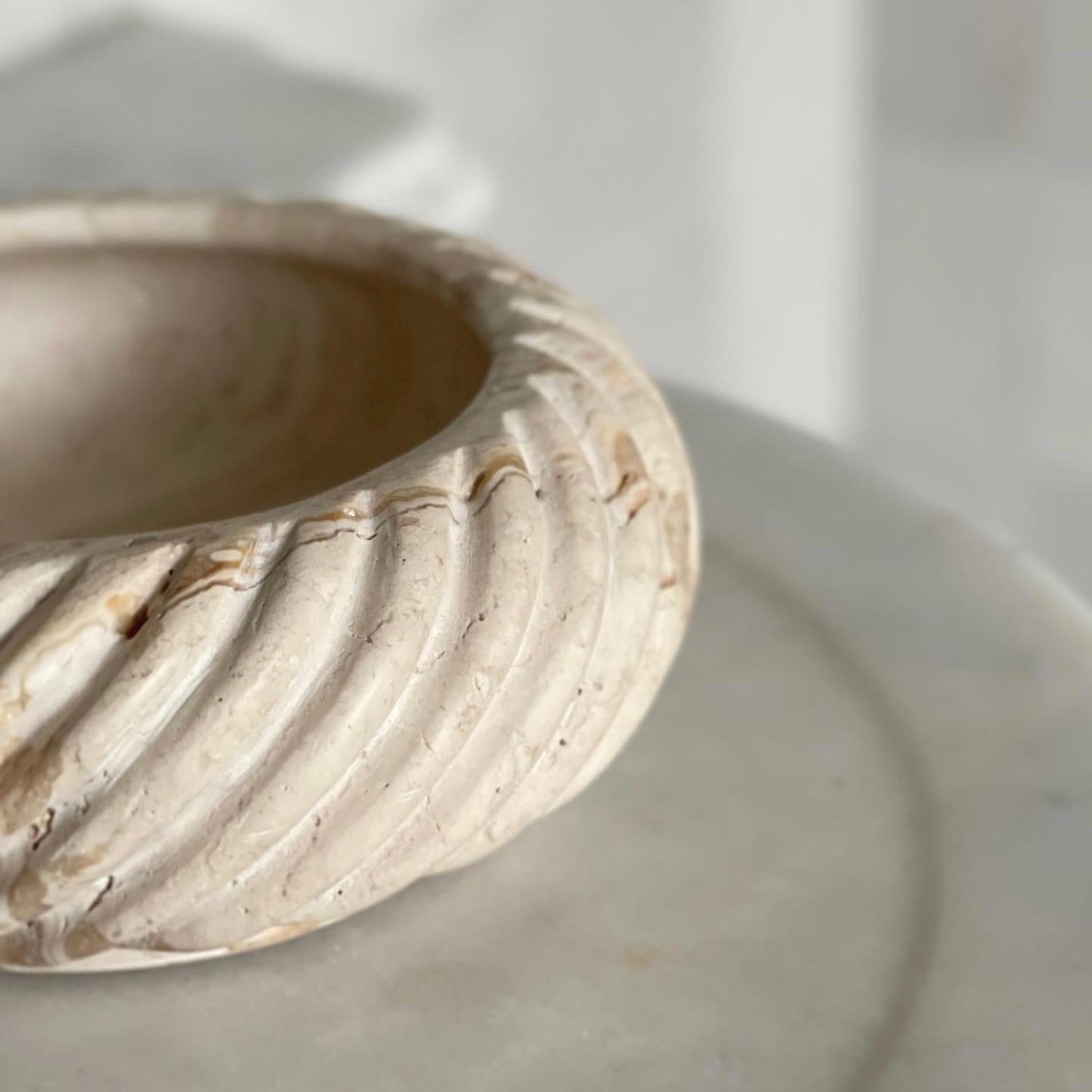 A limited production, functional object d'art exclusively produced by Anastasio Home.

The Cruller Bowl is a heavy set, nine-inch round bowl cut from a single piece of solid stone, hand-finished in a twisted rope motif by artisans in a growing