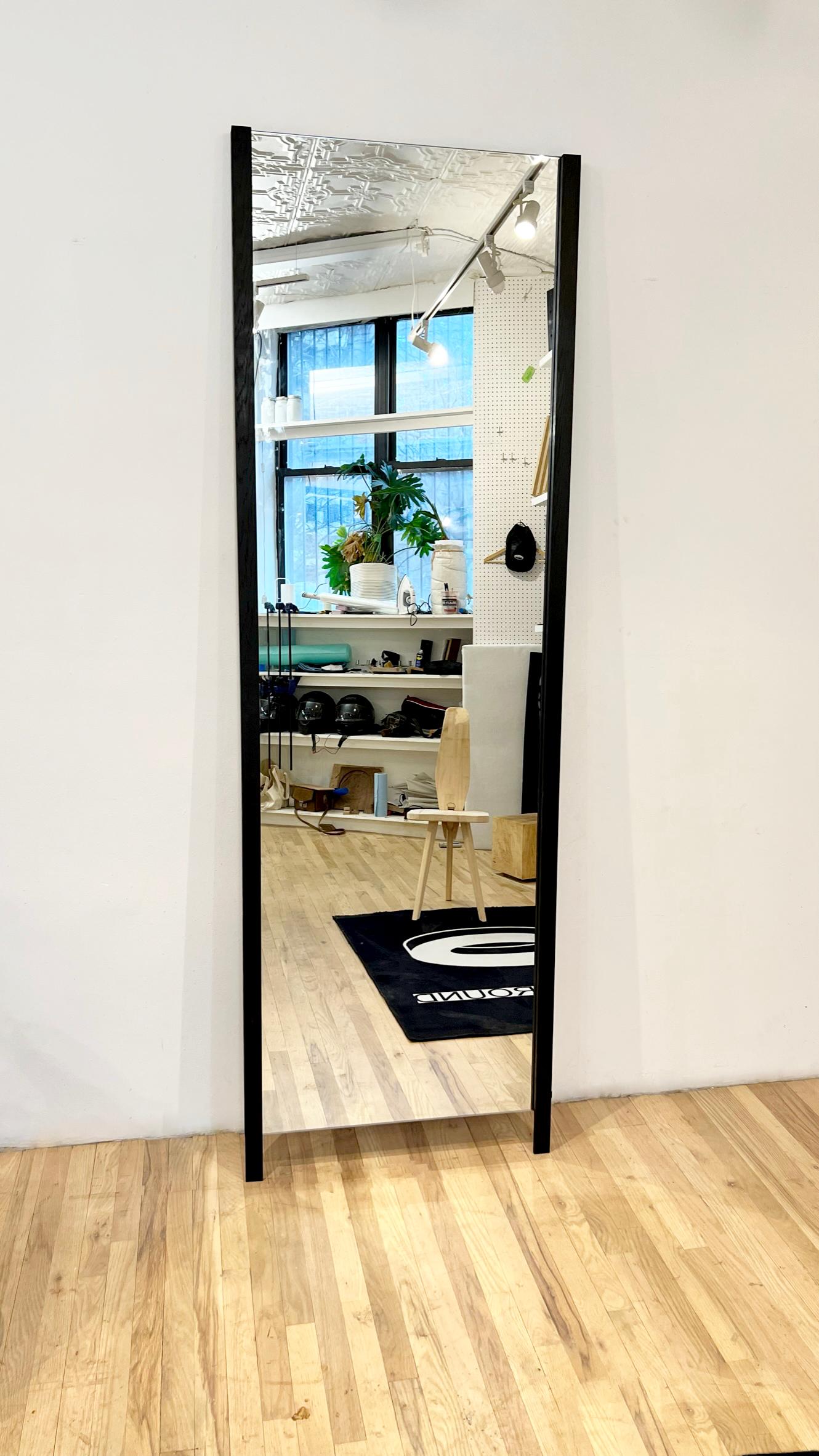 Constructed from black walnut the mirror is a portal to another universe. The Crura mirror extends the floor in an infinite illusion. Standing on two legs it doubles space and stands at your favorite wall for the creation of the day's outfit. The