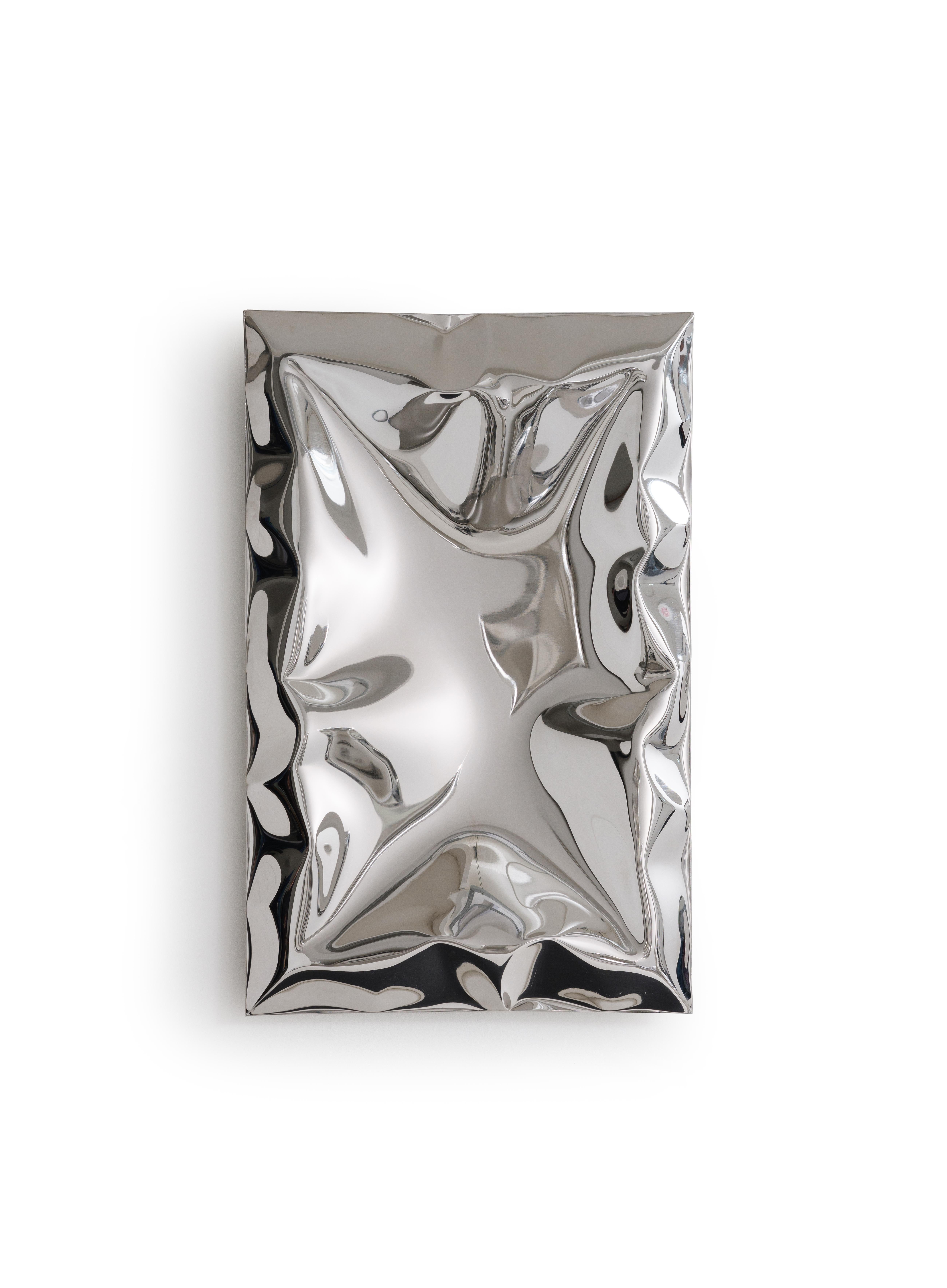 Inflated metal wall artwork, made from highly mirror polished stainless steel. The inflating metal is restricted in areas during forming to create a unique ‘crushed’ aesthetic. As you move around the artwork the myriad of reflections change and