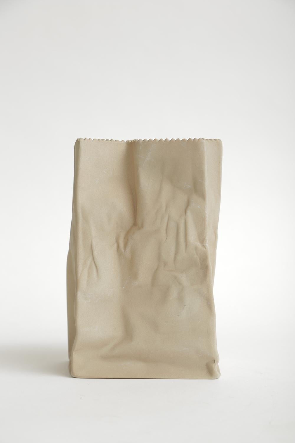 This crushed Rosenthal porcelain brown paper bag sculpture is vintage. It is from the 1970s. Always popular and desirable. It is part pop art and part modern sculpture in porcelain form. Please note: This is now on sale at a great price.