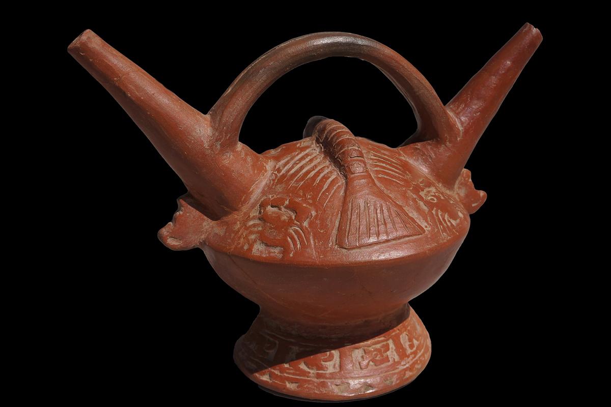 The vessel comes with an international Certificate of Authenticity.

This choice redware example has two identical spouts connected which are connected with an elaborate bridge handle. A large hand-modeled crustacean (lobster) in high relief is