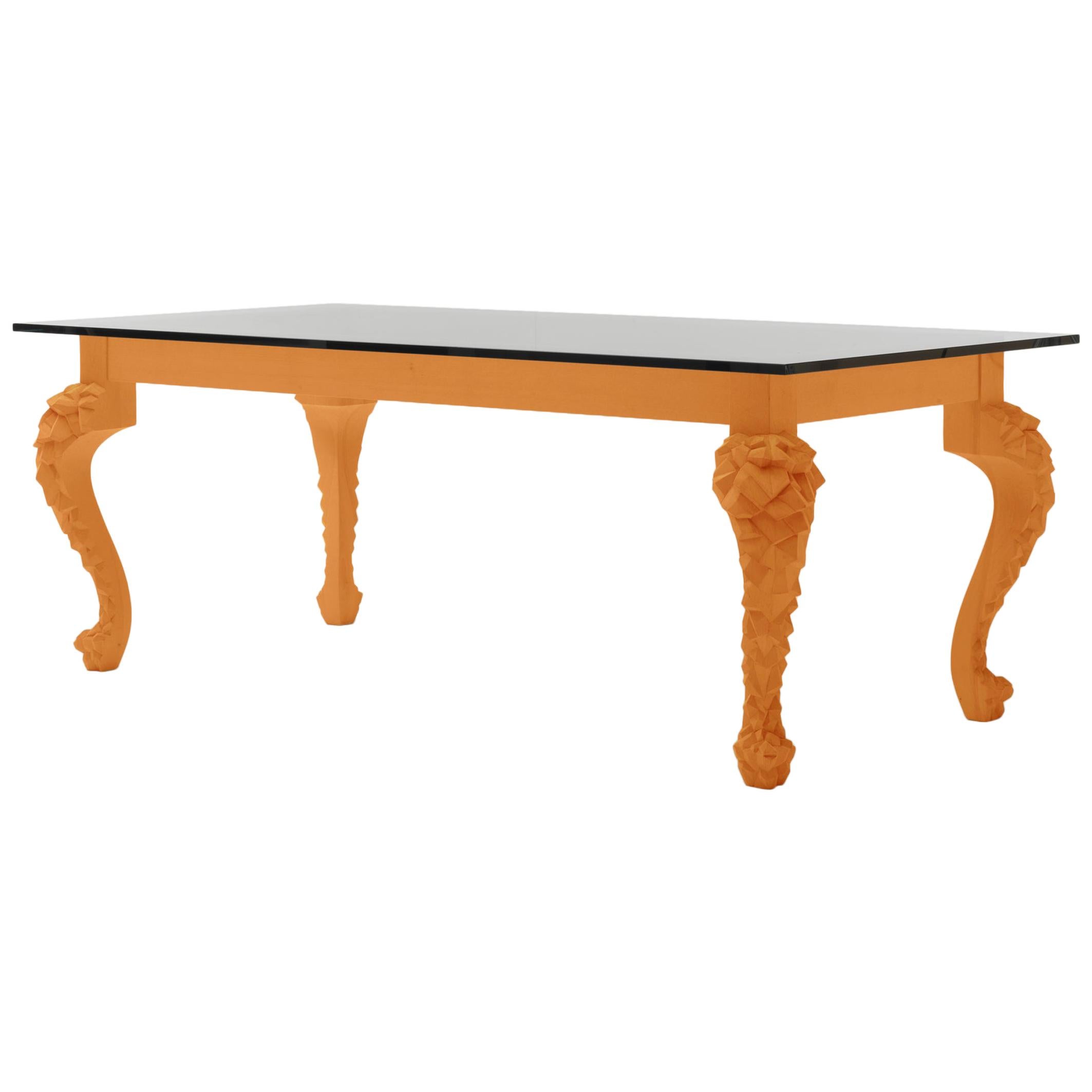 Table de salle à manger orange rustique avec pieds sculptés et plateau en verre par Nigel Coates