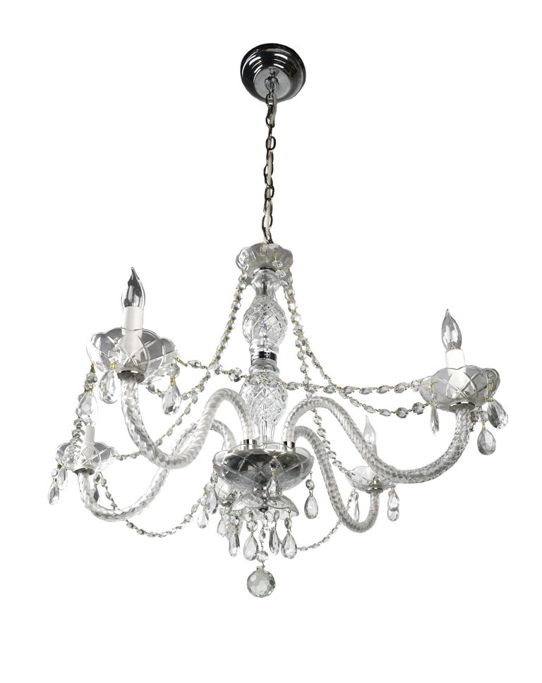This 5-arm chandelier features lovely crystal roping and hanging crystals throughout. A shimmering spherical orb finial hangs below surrounded by 5 symmetrical looping arms.

We find that early vintage lighting was designed as objects of art and we