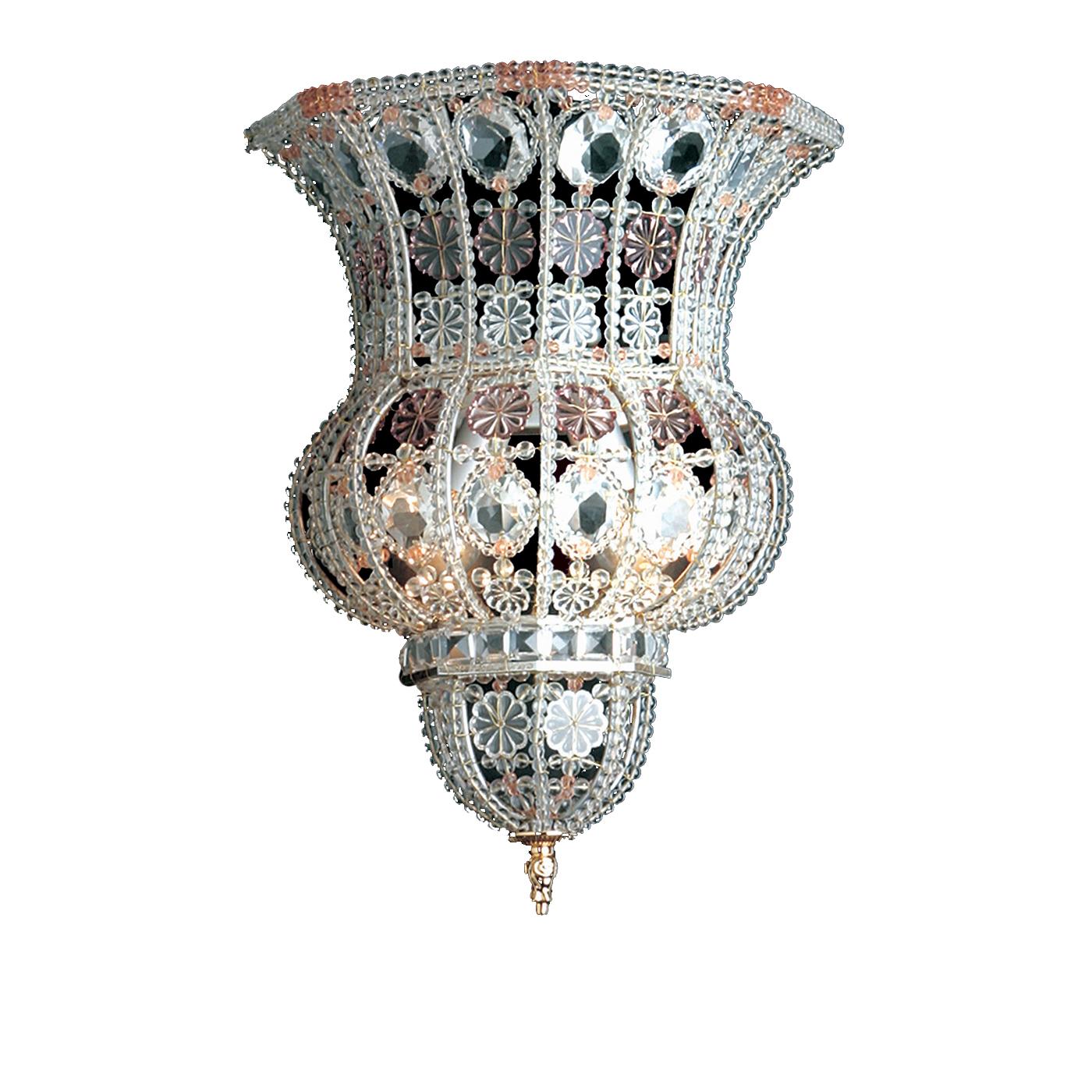 A sinuous silhouette and mesmerizing decorations make this sconce a superb addition to any home. Either in an entryway, powder room, or bedroom, this sparkling piece will make a sophisticated statement. Its forged-iron structure creates delicate