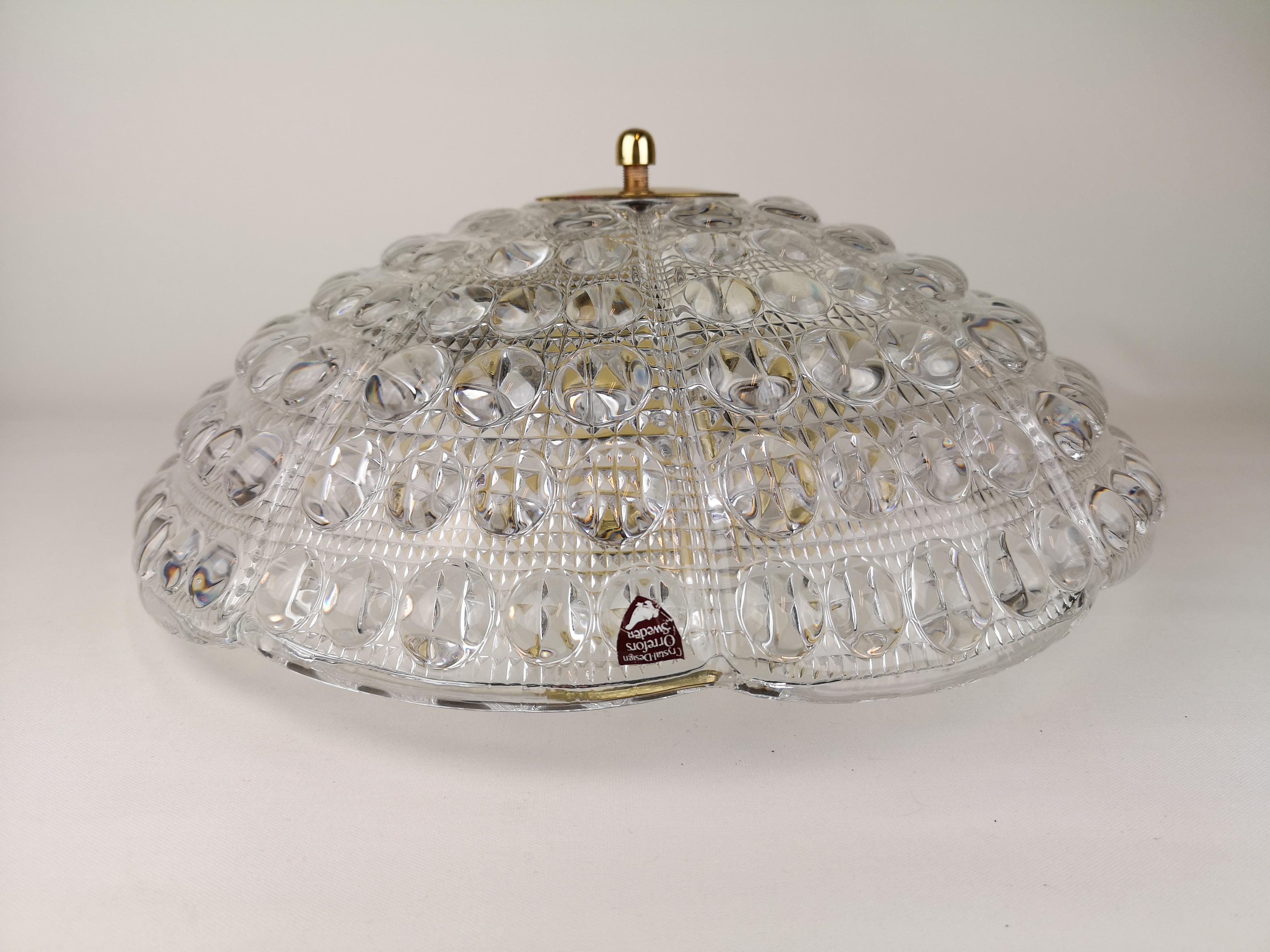 Beautiful ceiling lights designed by Carl Fagerlund for Orrefors, Sweden. The ceiling lamp is made of crystal glass and brass.

They are in wonderful working condition.
 