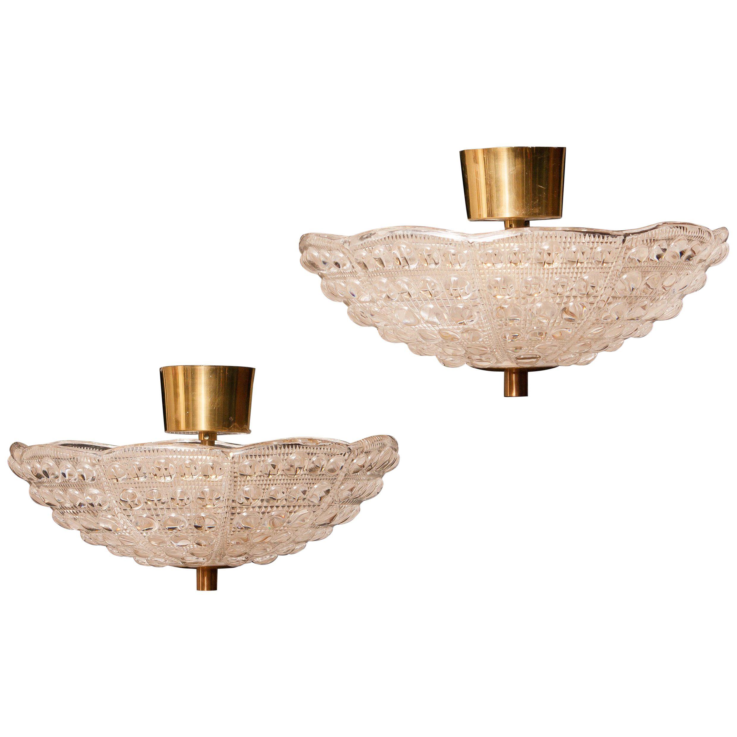 Beautiful pair of ceiling lights designed by Carl Fagerlund for Orrefors, Sweden.
These pendants are made of crystal glass and brass.
They are in wonderful working condition.
Period, 1960s.
Dimensions: H 20 cm, Ø 36 cm.