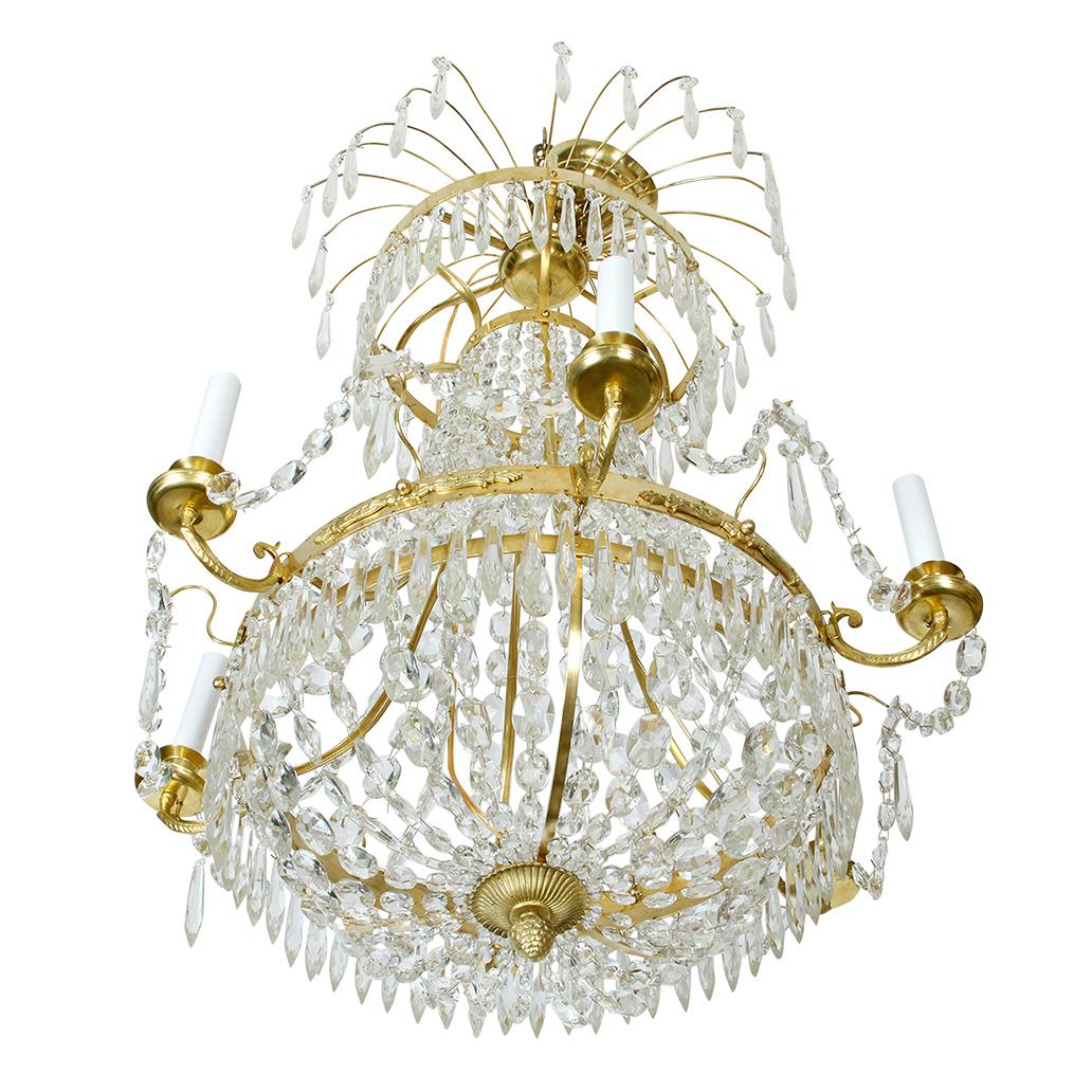 Crystal and brass Swedish chandelier with six arms and multiple tiers.