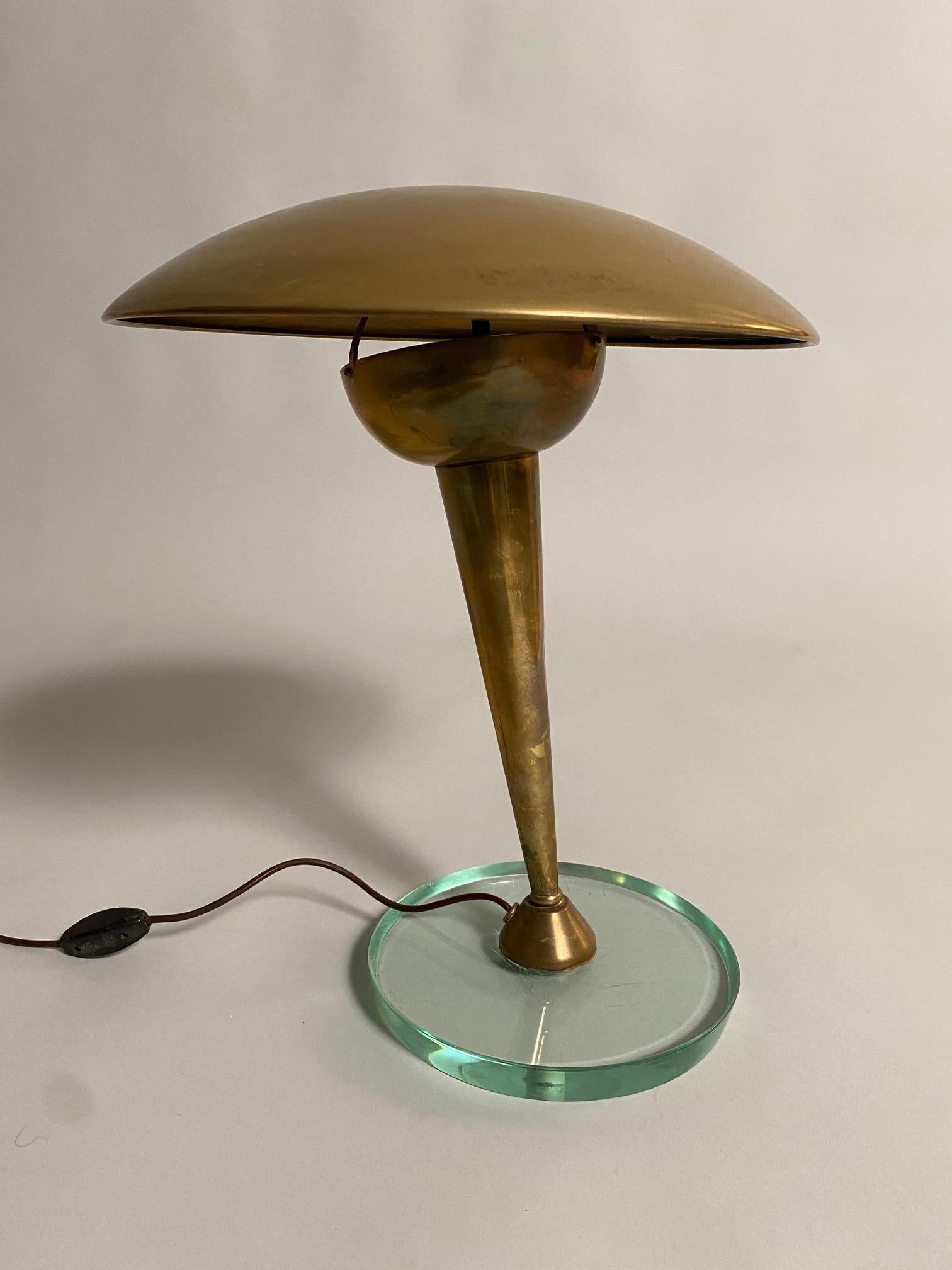 A refined and rare table lamp attributed to Pietro Chiesa for Fontana Arte. The lamp features a crystal glass base and a tapered brass stem. The lamp is authentic in all its parts, we can polish it but we preferred to keep the oxidation of the brass