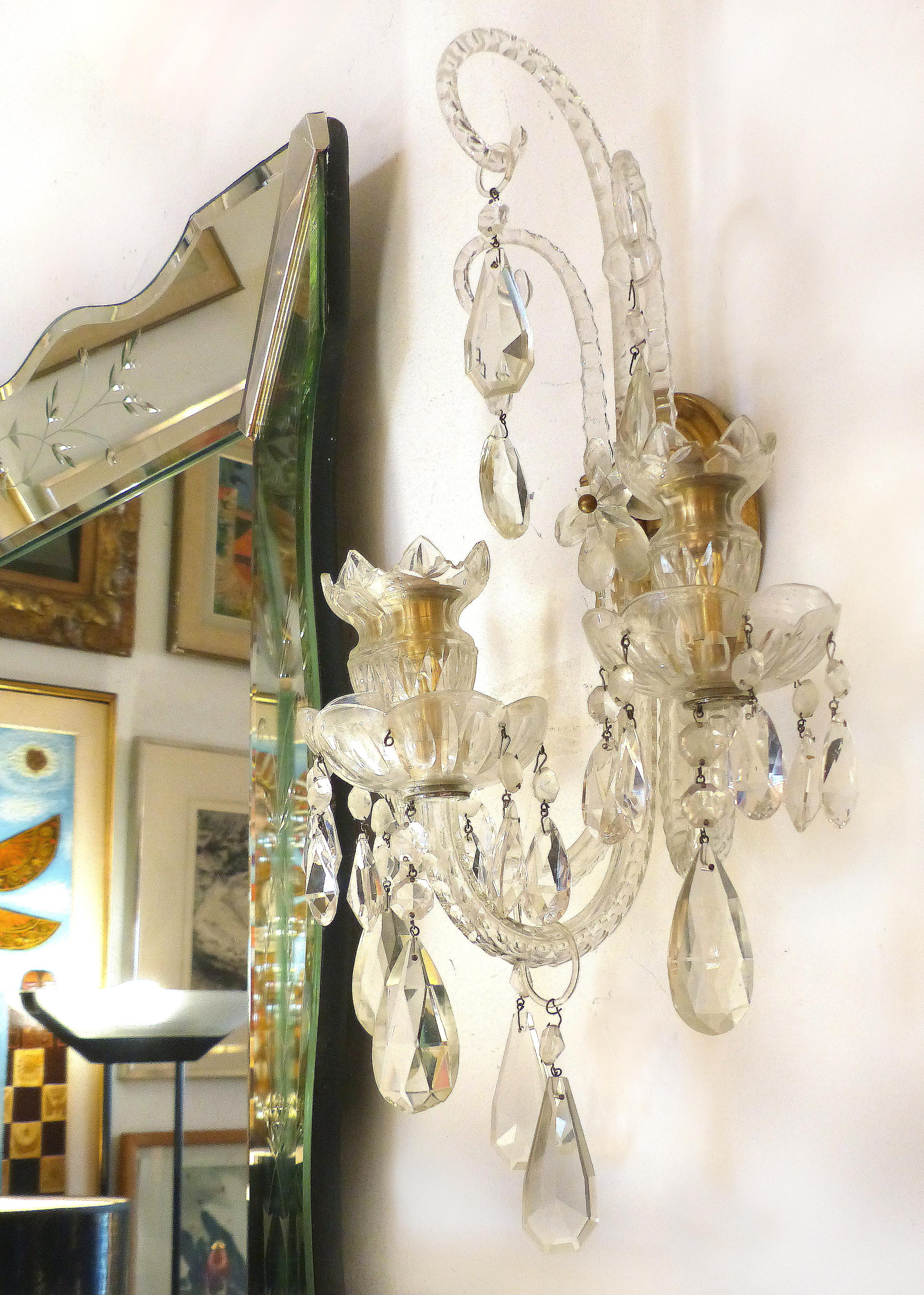 Crystal and Bronze 1940s 3-Arm Original Candle Sconces

Offered for sale is a fine pair of elegant crystal and bronze original candle three-arm wall sconces from the 1940s. The sconces have cut-glass decorated arms with crystal drops. There are