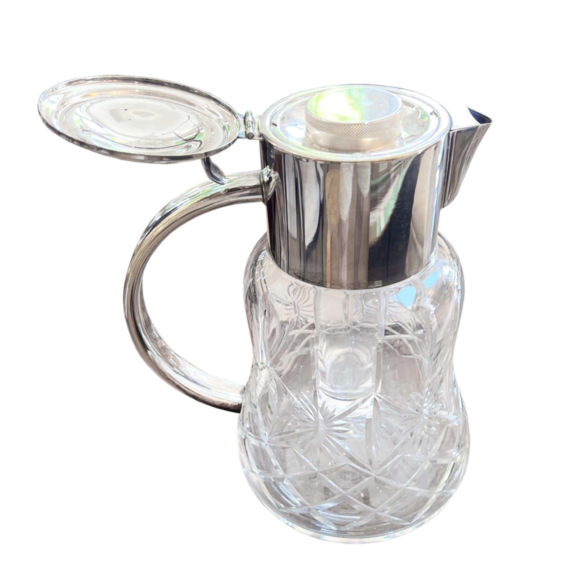 This is a fabulous cocktail or lemonade jug. Made from crystal glass with a silver plated top. 

It is very decorative and extremely practical.

How to use - simply remove the glass ice canister from inside the jug, fill it with ice and replace the