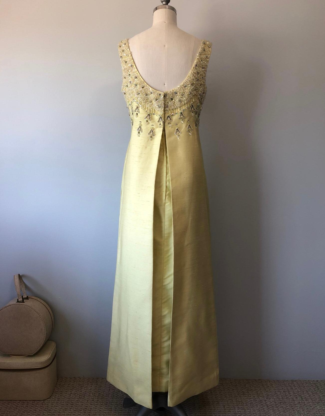 Gorgeous 60's gown that would look just as current and glamorous today. A vibrantly colored silk dupioni fabric that gleams in the light, along with, of course, its crystals, beads, and rhinestones. This would make a spectacular rehearsal dinner