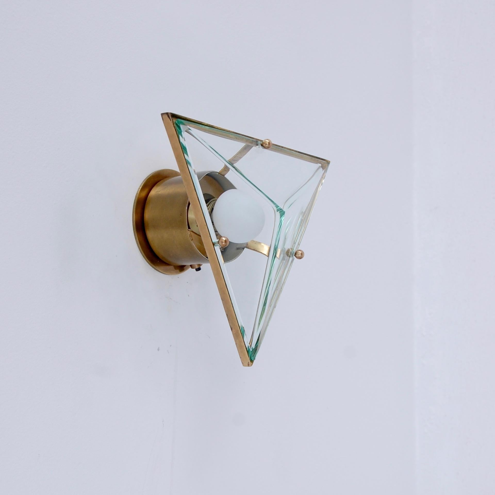 Pair of brass and glass triangular sconces by Crystal Arte from Italy. Partially restored, original patina brass finish, and glass. Single E12 based socket per sconce. Maximum wattage 75 watts per sconce. Back plate has 
2 ¾” center to center