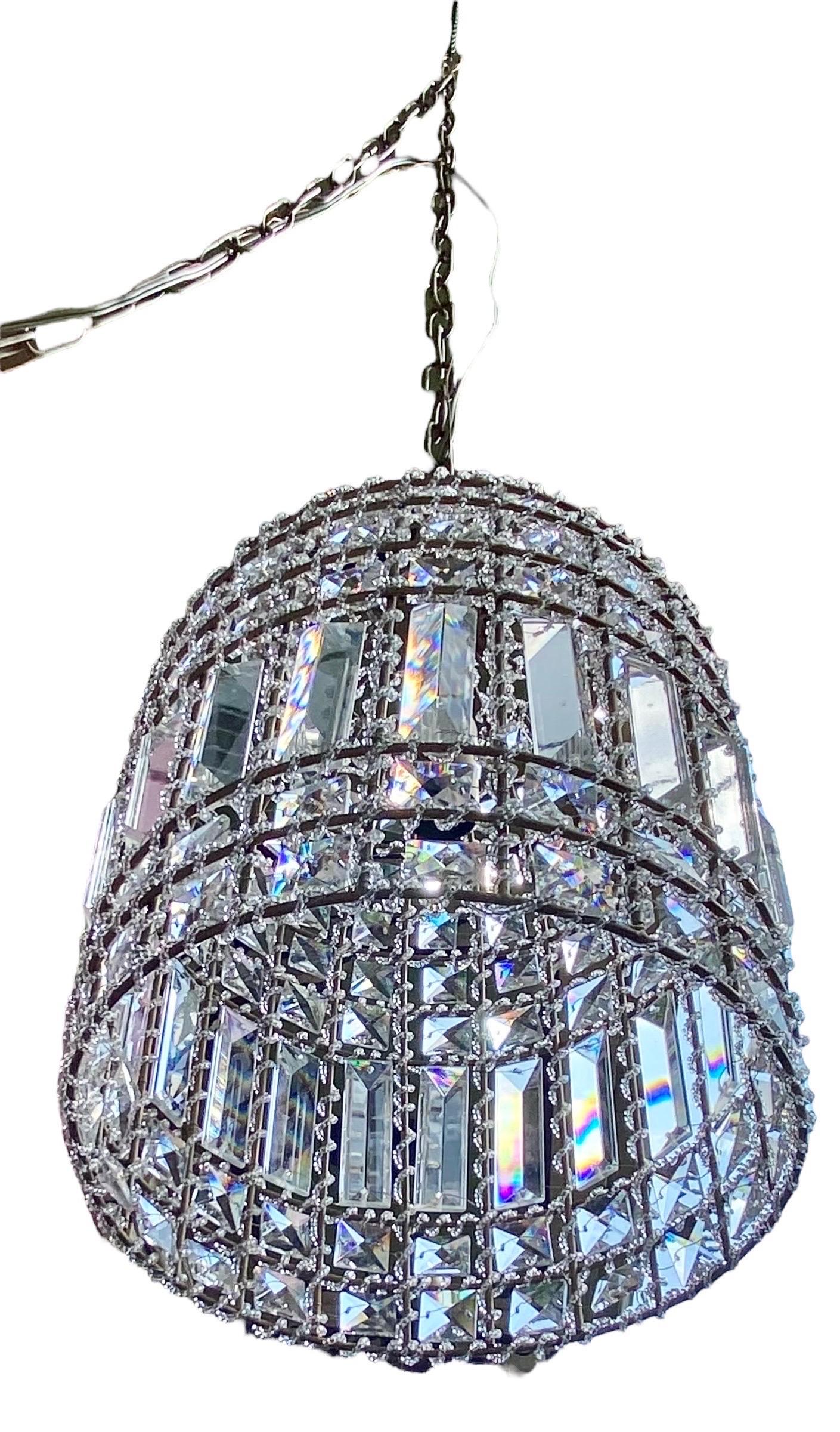 Simple yet elegant, this contemporary pendant chandelier will illuminate your space. It has a luminous dome metal frame with multifaceted crystals for an eye-catching look which requires a
40-watt candelabra style bulb for an enhanced and