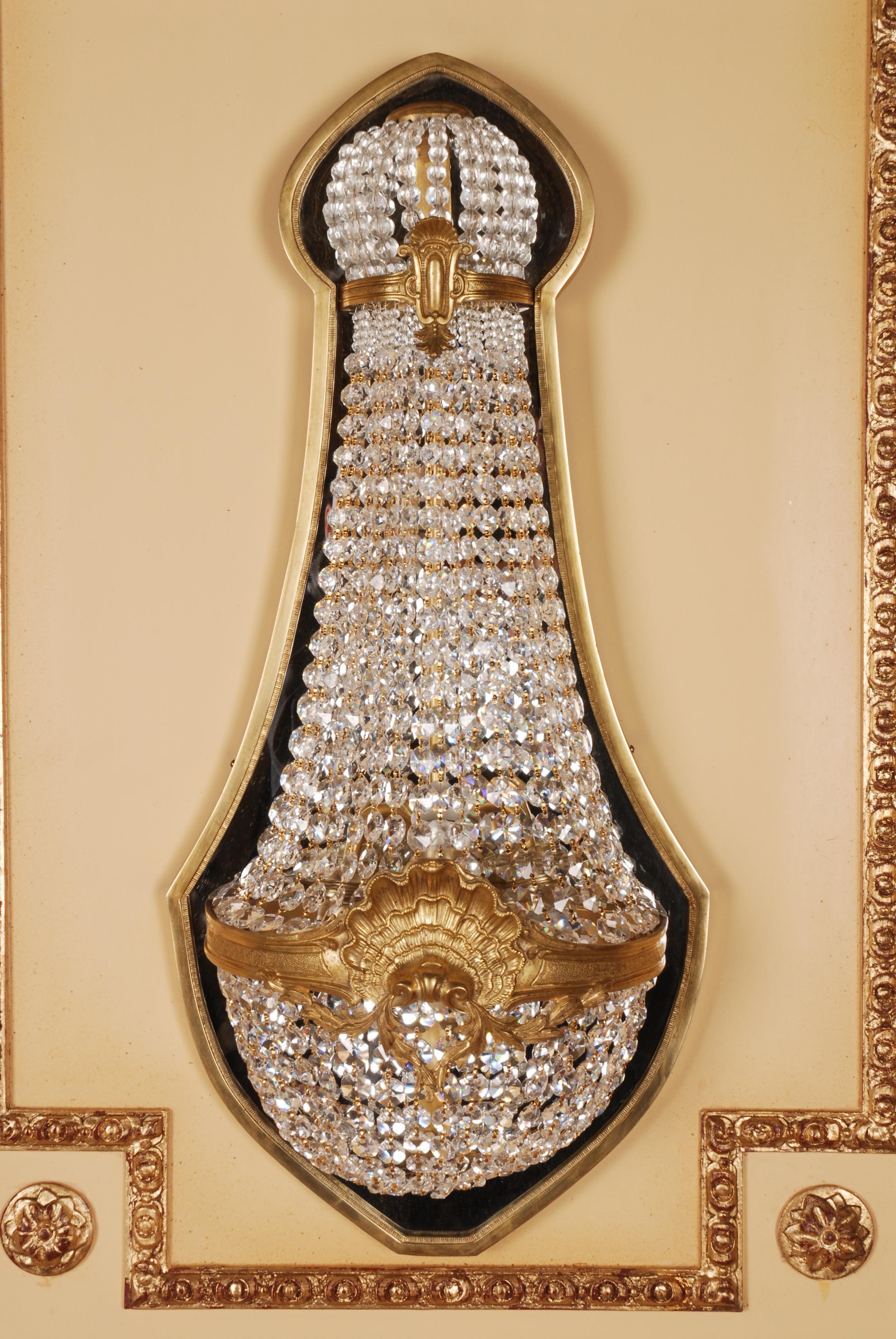 Crystal basket wall light in Louis XVI Style 
 Wall Light from finely engraved Bronze. Finely ground crystals.
 Measures: Width: 35 cm, Height: 76 cm, Depth: 17 cm.
 