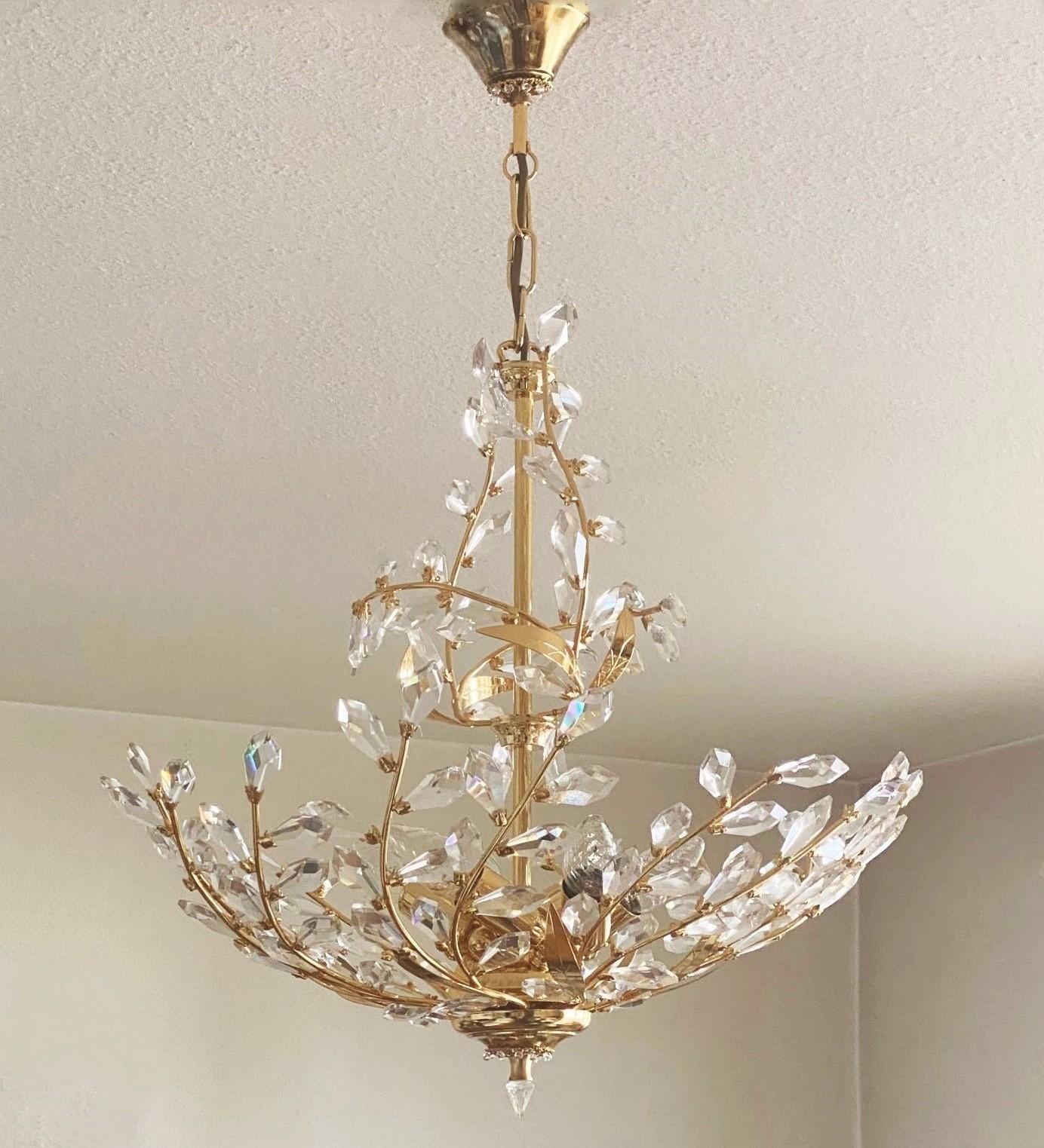 A very elegant crystal six-light chandelier in the style of Maison Baguès, France, 1960s. This wonderful and rare handcrafted fixture is made of gilded brass and faceted crystals. In fine vintage condition, crystals complete, recently rewired. It