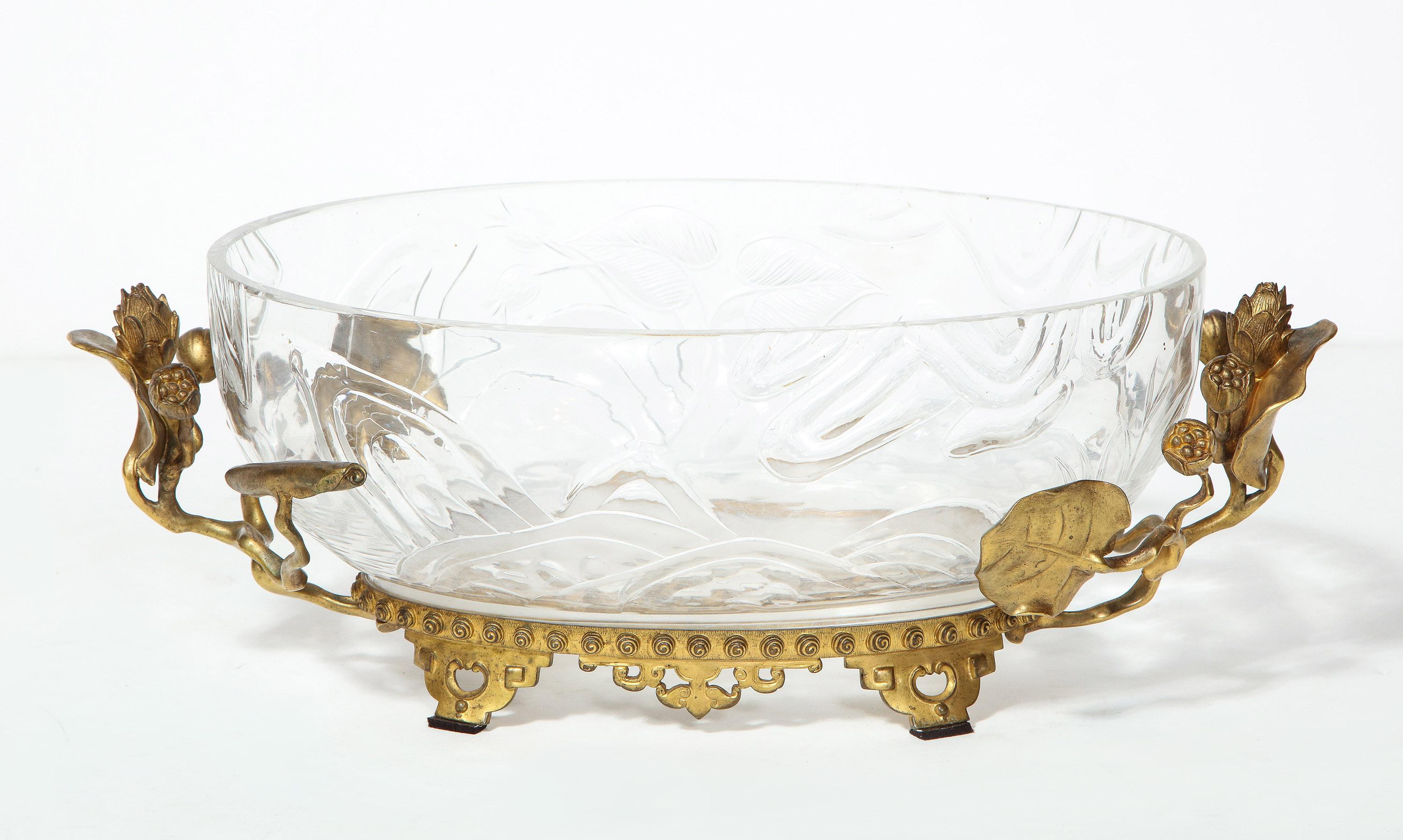 Art Nouveau bronze mounted crystal bowl

The crystal bowl with molded floral design, supported by a bronze frame of vines, all on an Asian design inspired base.