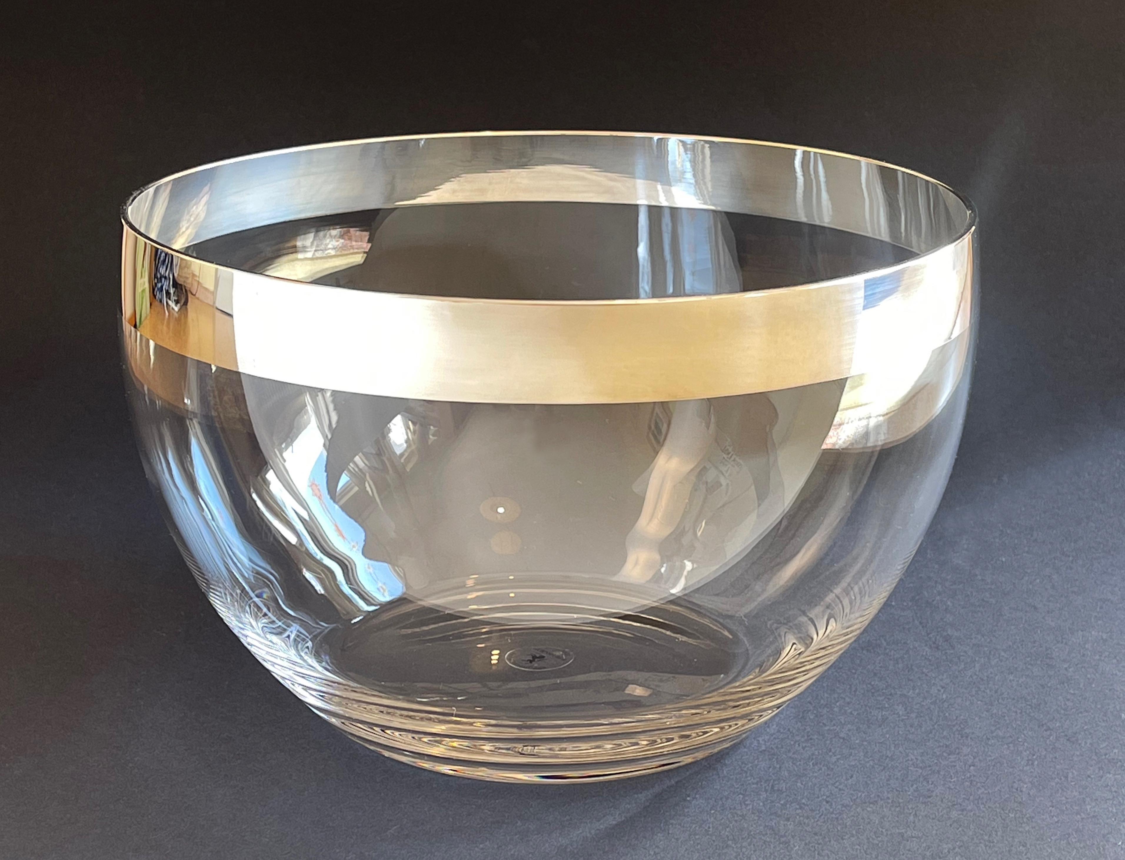 Sonja Quandt bowl for Kühnsilber, Germany.
Contemporary serving bowl made by hand of crystal glass, finished with a fine-silver rim (1000/1000). 
The silver rim is applied to the crystal glass by hand with a brush.

The unicorn hallmark:
Sonja