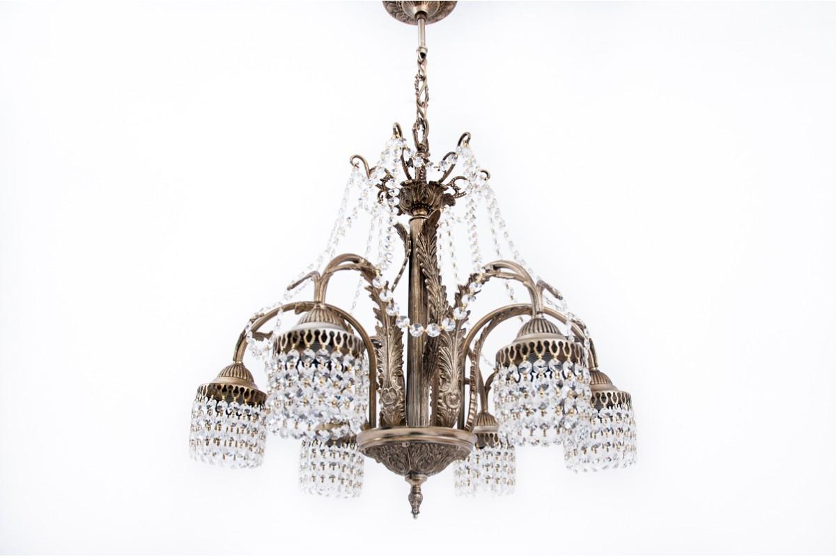 Brass chandelier with crystals from France from the 1940s. 
The chandelier has been renovated, the electrical installation has been replaced.

Dimensions: height 87 cm / dia. 58 cm.