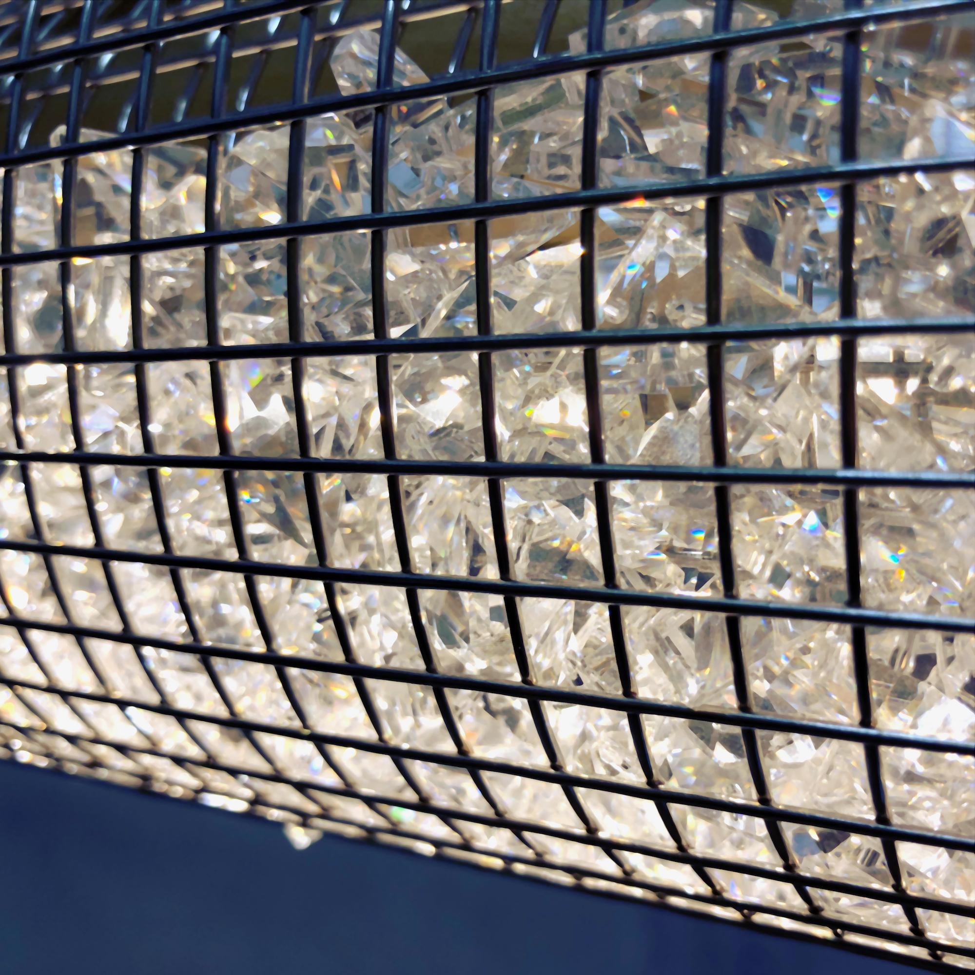 New for 2022, The Crystal Cage LED Pendant shines powerful LED luminaries through a stainless steel cage full of gorgeous chandelier crystal for a sleek linear suspension that provides the most natural shimmer and sparkle available in any