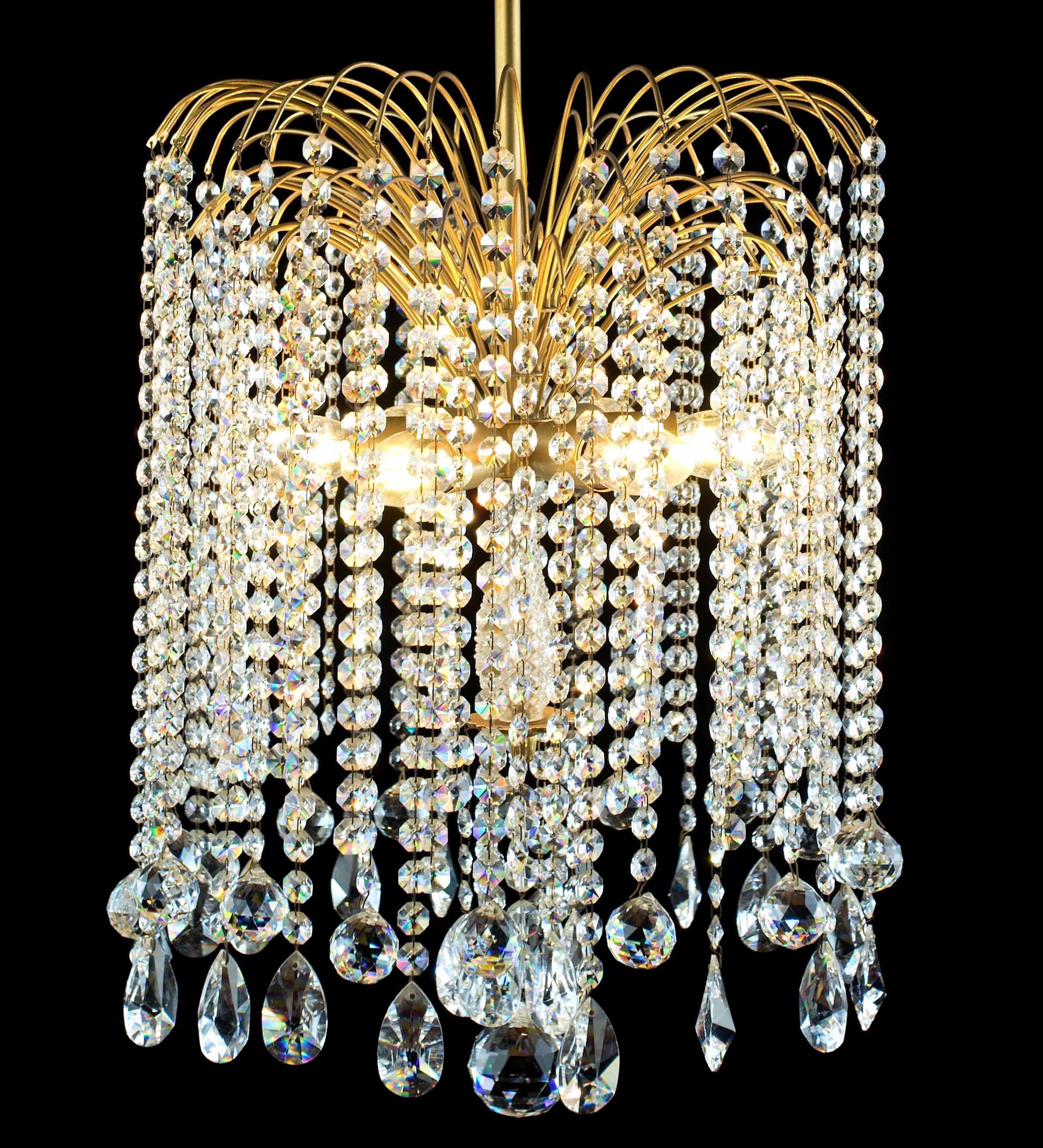 A brass chandelier with a rich cascade of lead crystal crystal pendants. The oats are hand-ground and polished. This model is quite rare and will light up the interior day and night. The chandelier is for six classic candle bulbs with an E14 socket