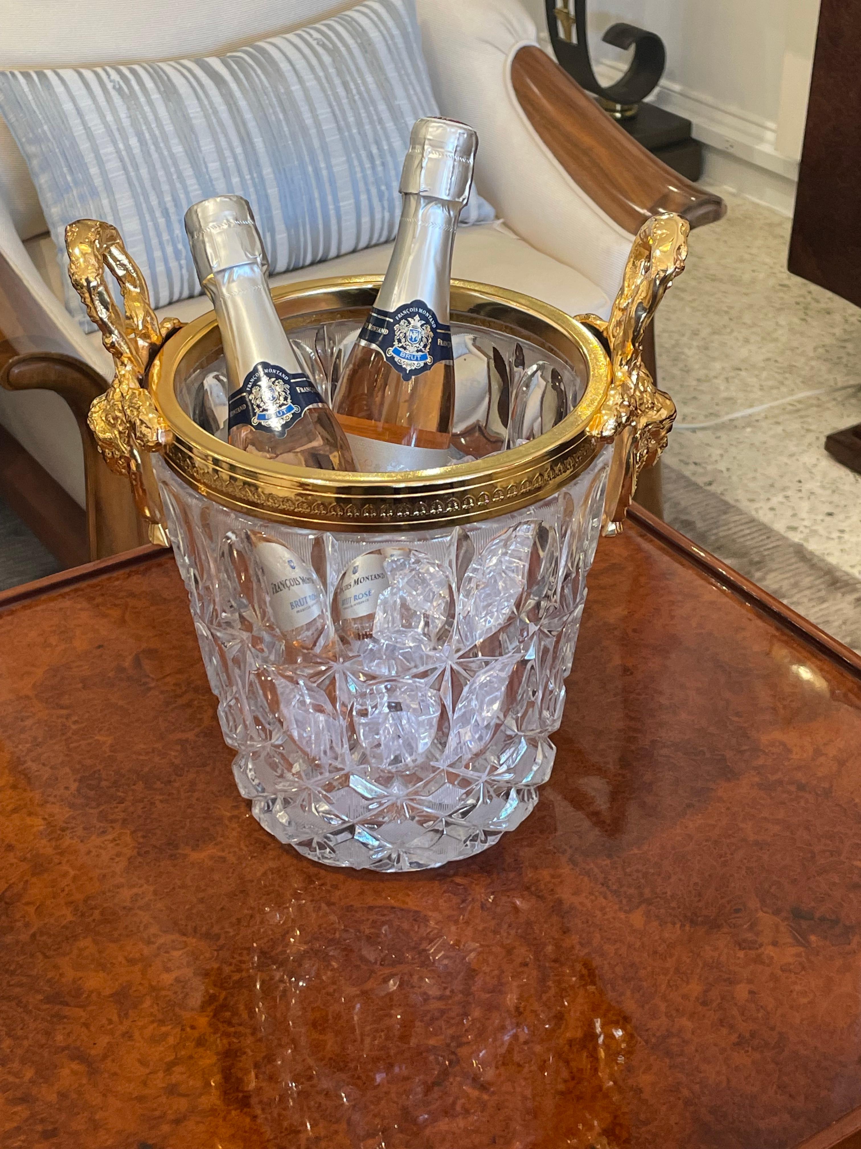 A crystal champagne / ice bucket with gilded details.
 