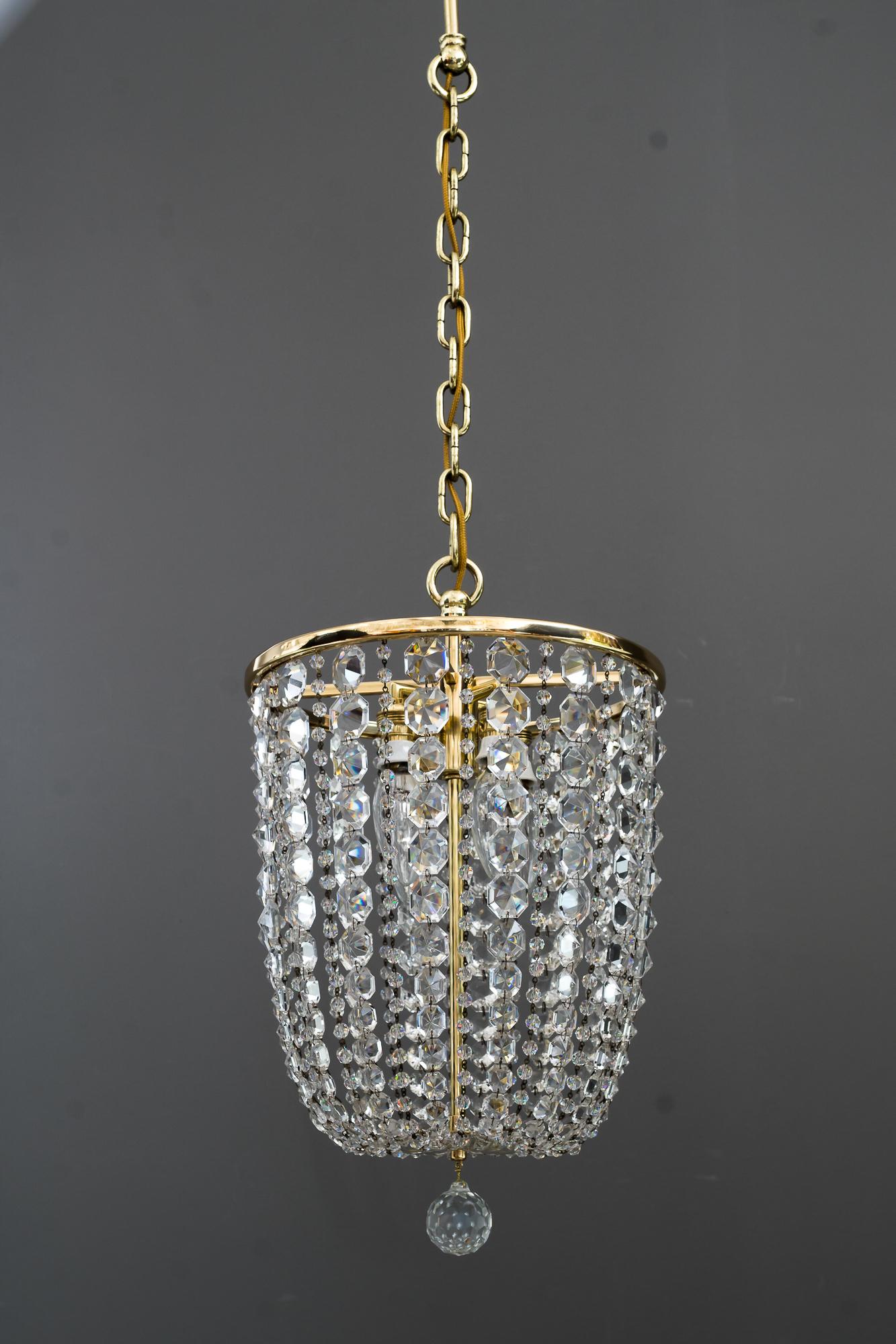 Crystal chandelier by Lobmeyr ( signed )
Brass polished and stove enamelled.