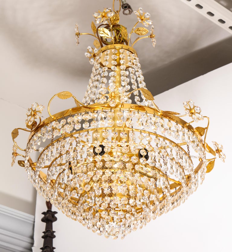 Tiered crystal and brass chandelier with flowers, vines and leaves by