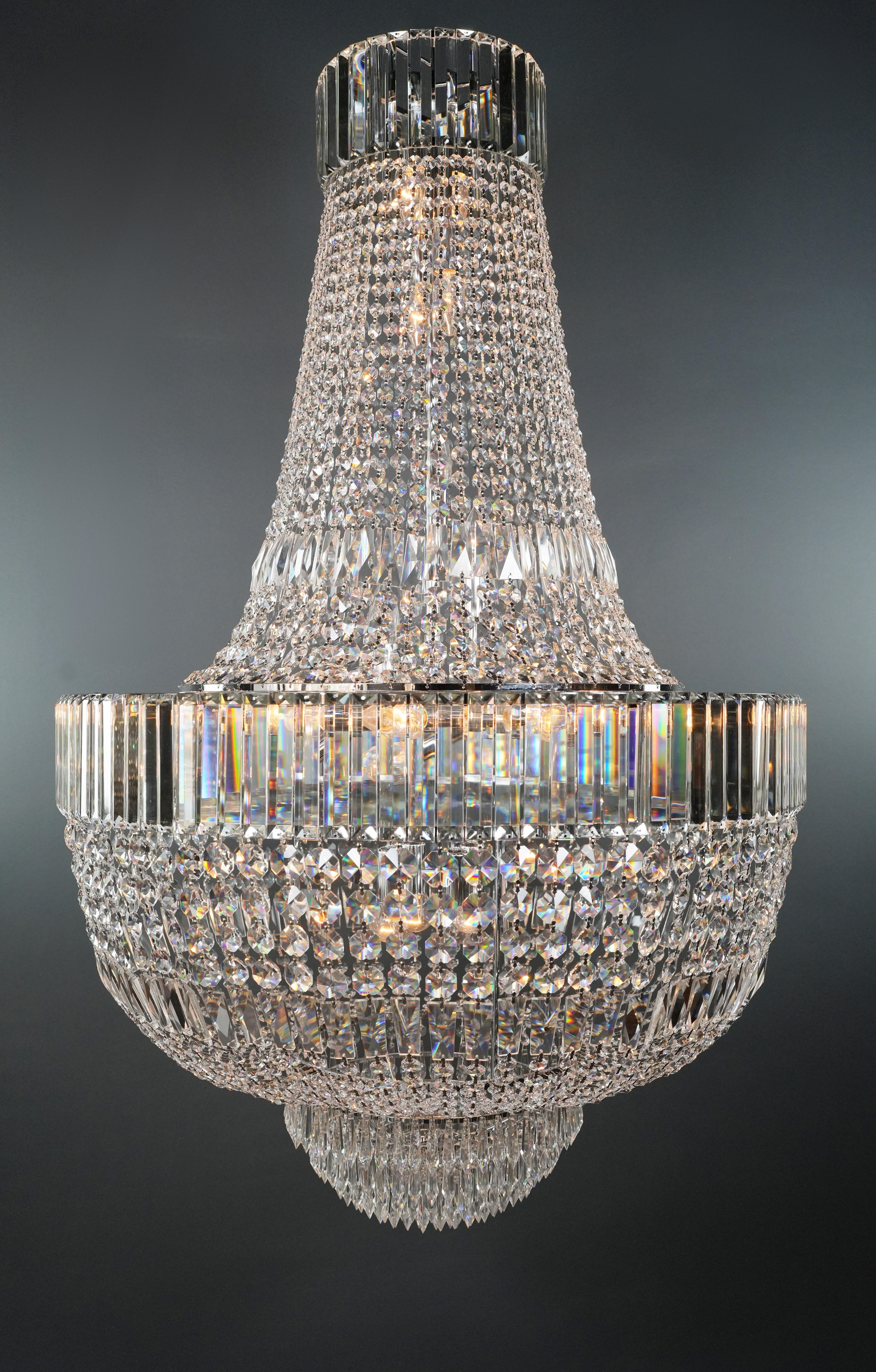 Introducing a captivating blend of Art Deco charm and Empire sophistication, our lead crystal chandelier is a testament to opulence and craftsmanship. Crafted in-house, we offer the flexibility of both smaller and larger sizes, ensuring the perfect