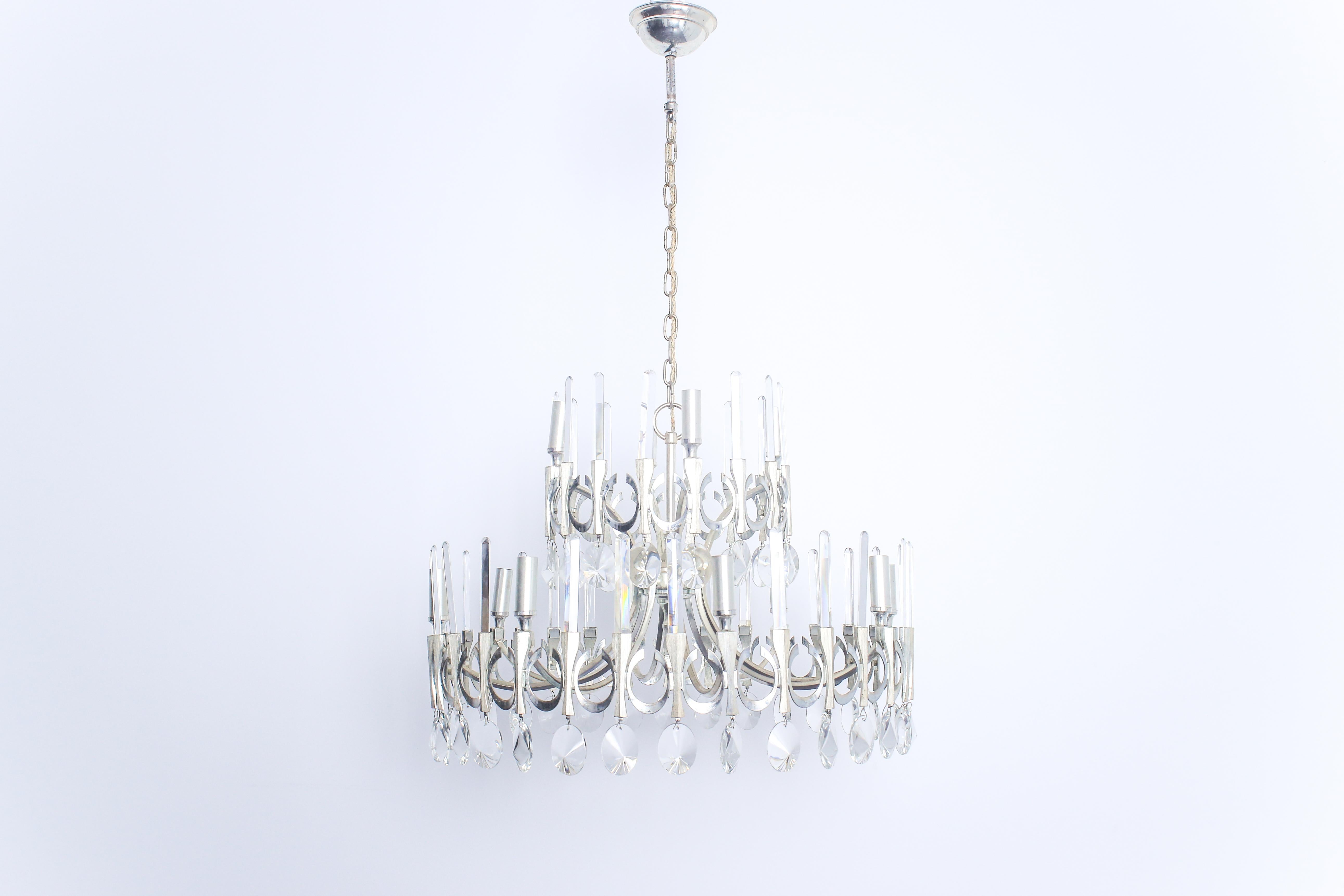 Twelve round chandelier with crystal pendants and fixed crystal rods on two levels. In excellent condition, wiring has been checked and confirmed to be sound, newly cleaned.