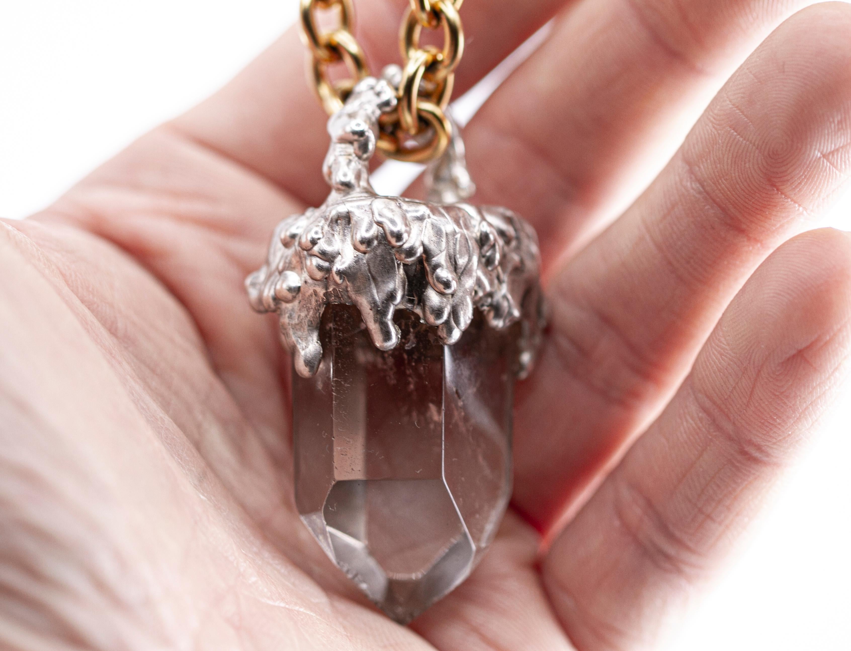 I think it's crystal clear. It is a very large hand carved silver amulet with a piece of raw quartz.

It's ice cream that melts on a block of ice.

This pendant is a one of a kind contemporary jewellery hand sculpted by the French jeweller Binliang