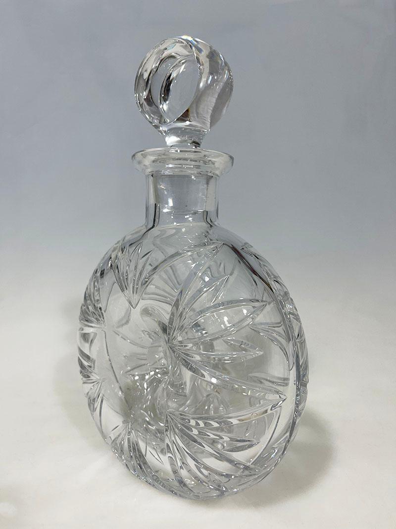 Crystal cut Whiskey decanter by Atlantis

A beautiful half round crystal cut Whiskey decanter with a hole in the middle. A round shape with dimensions 15 cm diagonal and 7 cm wide and 24 cm high with stopper. A heavy quality crystal made by