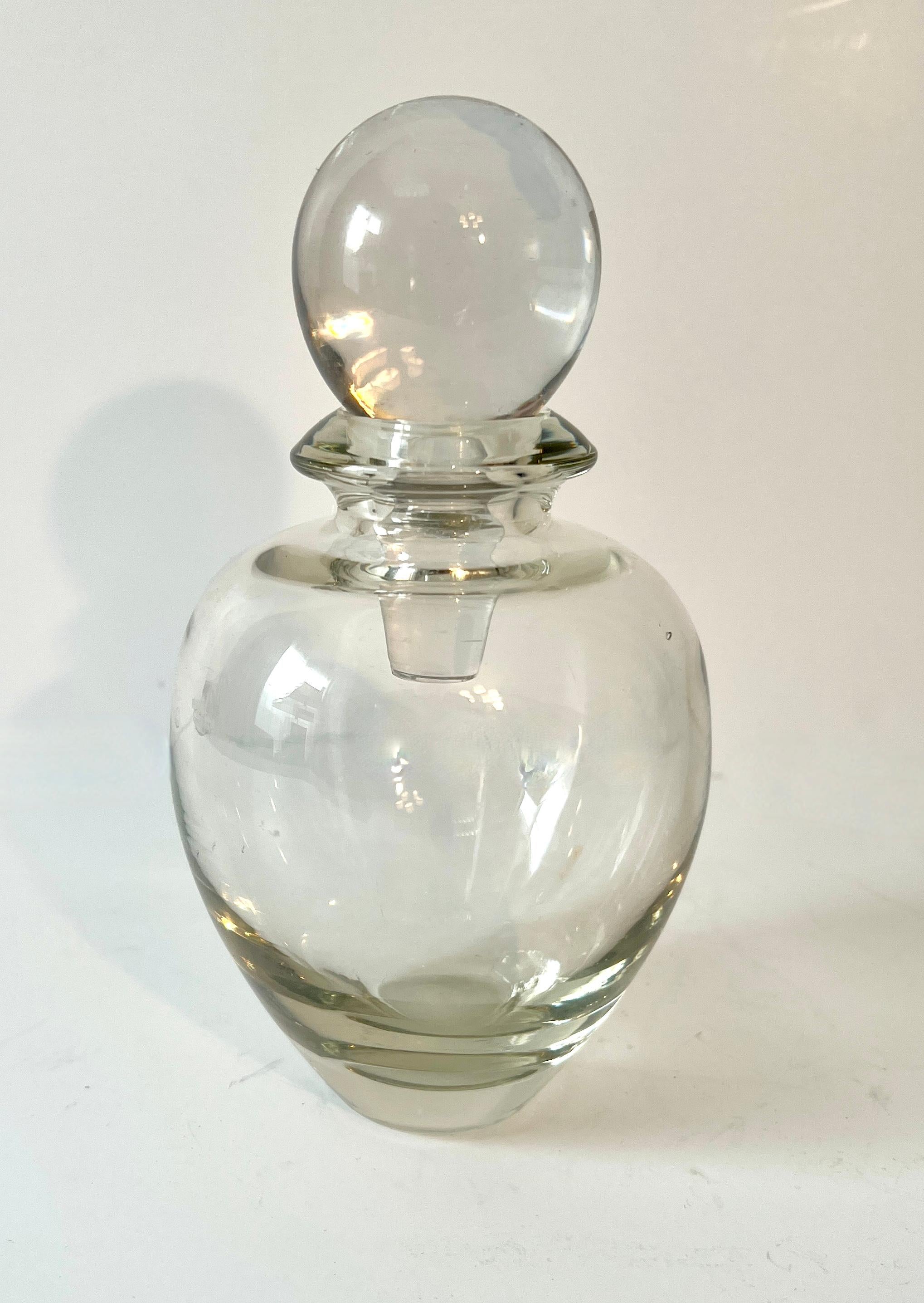 A small and beautifully styled decanter - While we most often times use decanters for the bar, they make great vessels for mouth wash, bubble bath, body washes, or herbs in the kitchen.

This decanter is a lovely bulbous shape with a nice large